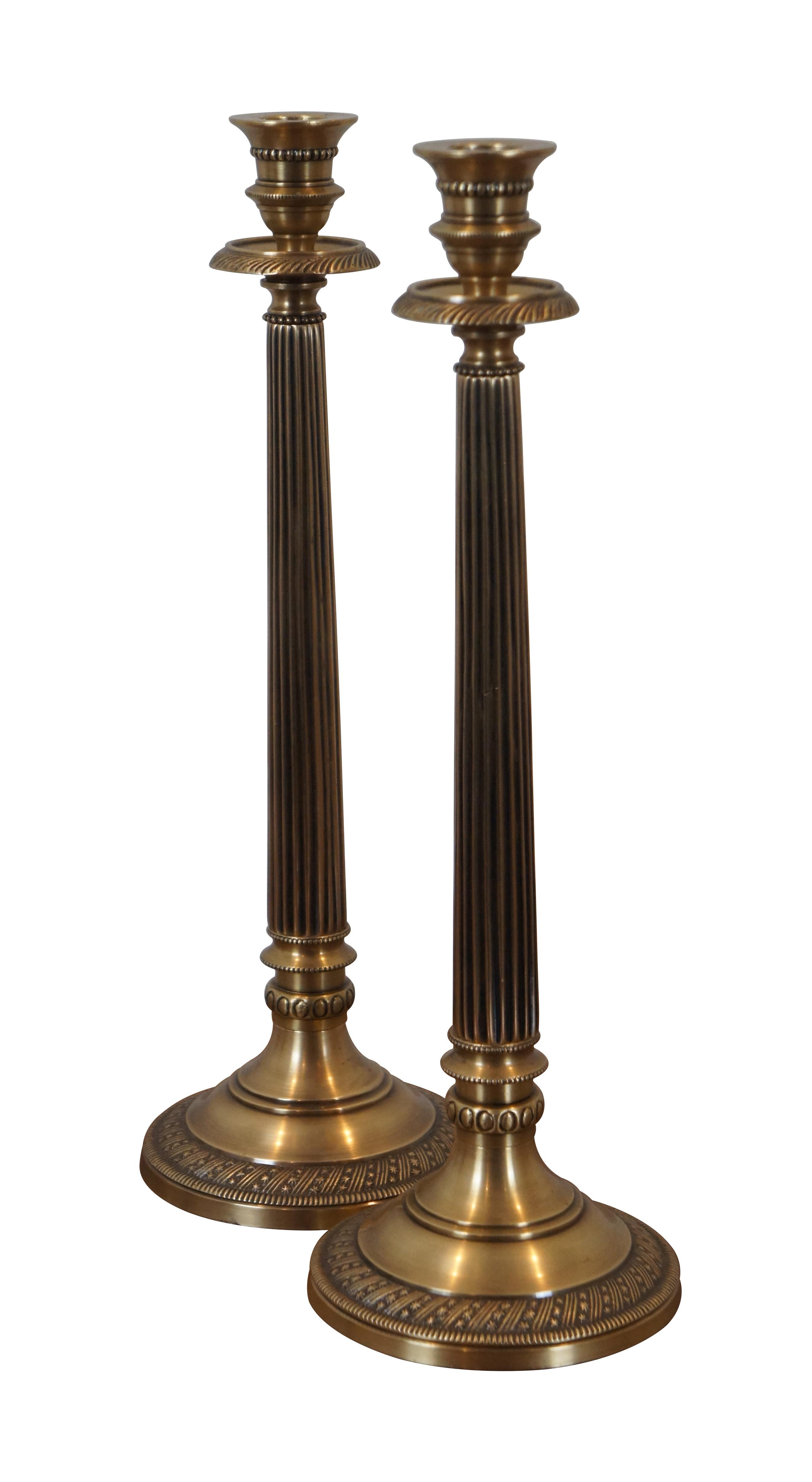 Pair of large vintage brass candlesticks / taper candle holders. In the shape of a neoclassically inspired fluted Corinthian column with beaded bands and a round base trimmed with a rope twist of alternating bands and stars.

Dimensions:
4.75” x