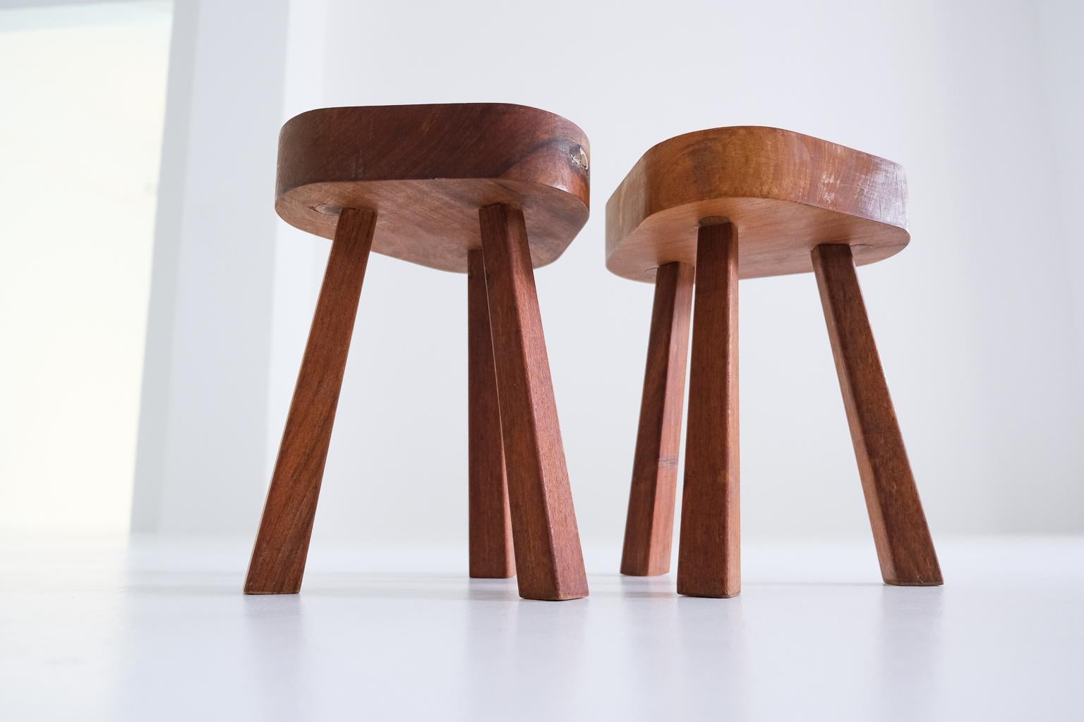 A pair of stools that can be used even better as small side tables. Made of solid wood, the design is reminiscent of the work of Charlotte Perriand or Pierre Chapo. 

Slight signs of use on the surface. 