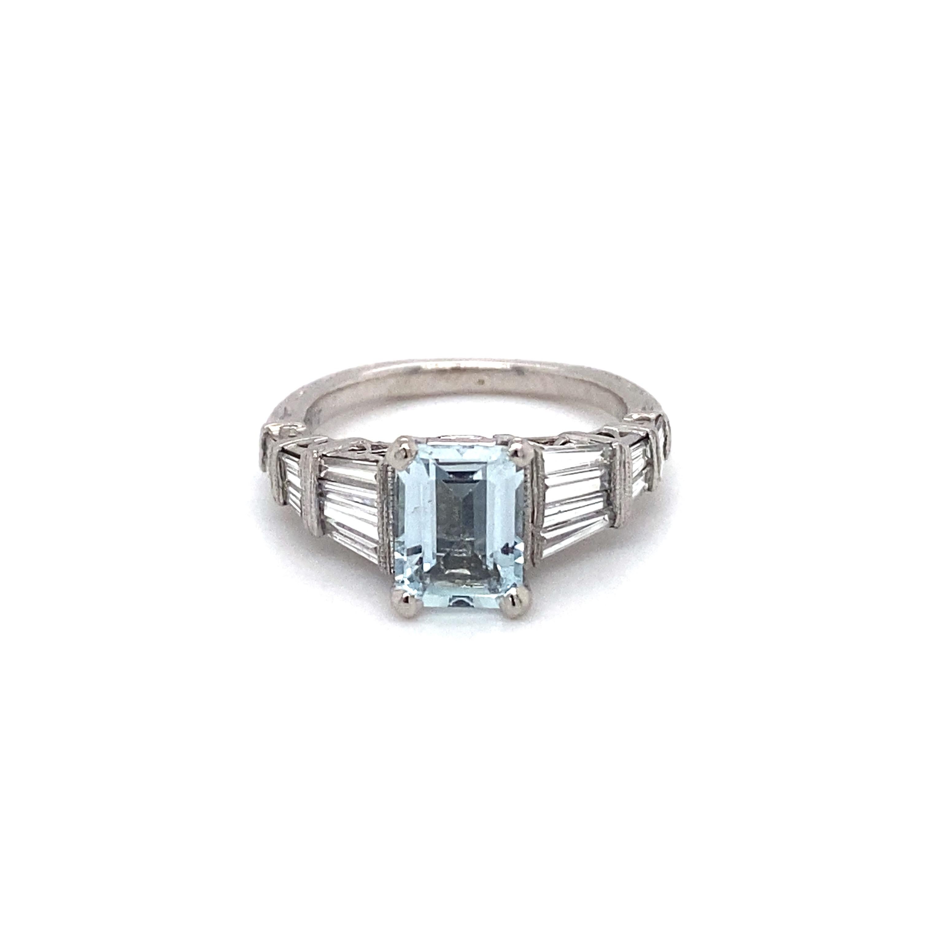 Circa: 1980s
Metal Type: Platinum
Weight: 7 grams 
Size: US 6.25 (resizable)

Diamond Details:

Carat: 1.17 carat total weight
Shape: Tapered baguettes
Color: G
Clarity: VS

Aquamarine Details: 

Carat: Approximately 2 carats
Shape: Emerald