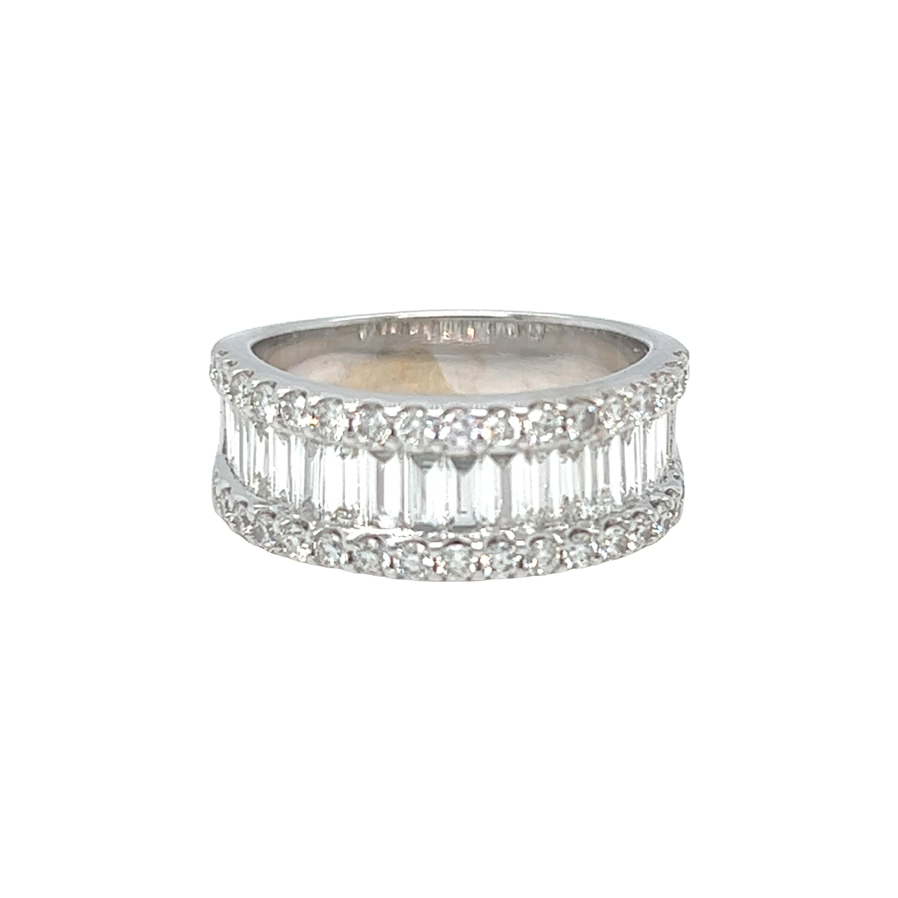 This modern designed half eternity ring features mixed cuts of baguette and round brilliant cut diamonds, G-H color and VS clarity. The total weight of diamonds is approximately 2 carats. The diamonds are set in prongs half way down the ring for