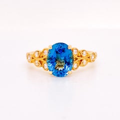 Bague en or jaune 14 carats avec zircon bleu et diamants inspirée de la Nature