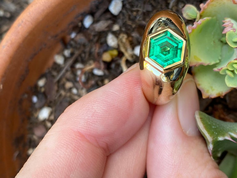 This Colombian emerald is cut in a rare shape that highlights its truly mesmerizing crystal. 

Certified minor treatment, this emerald is two carats in weight. 

The signet ring is hand carved, and wax cast by Kate Lee Short here in California,