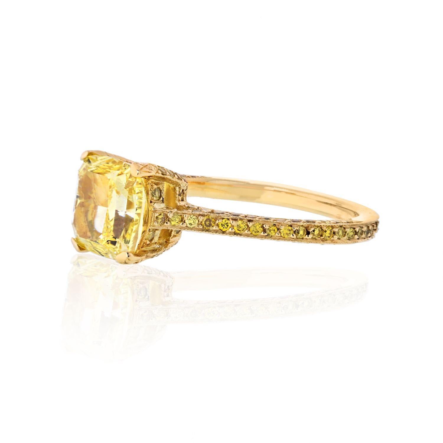 This is a lovely fancy yellow diamond engagement ring for someone who is after a very special jewel. Crafted in 18K yellow gold this ring is mounted with a 2.15 carat Cushion Cut Fancy Yellow Intense diamond that is GIA certified SI1 clarity.