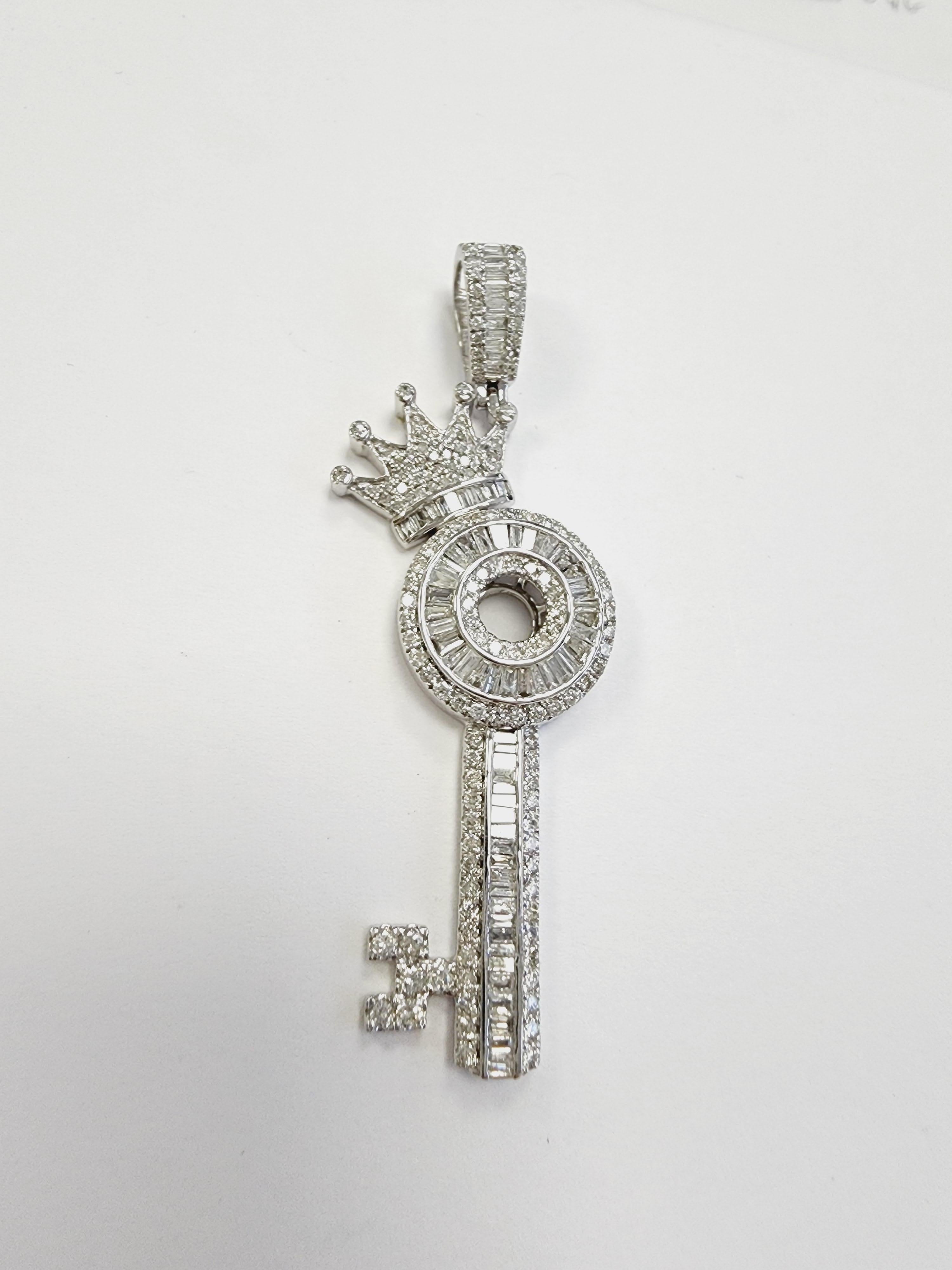 Beautiful shiny, 2 cttw Crown Key Shape Pendant 14 Karat White Gold. average Color H-I, Clarity SI-I.
Channel Set of Baguettes and Round Natural Diamonds.
Measurement 2.25 inch long x 0.75 inch wide x 0.25 inch height