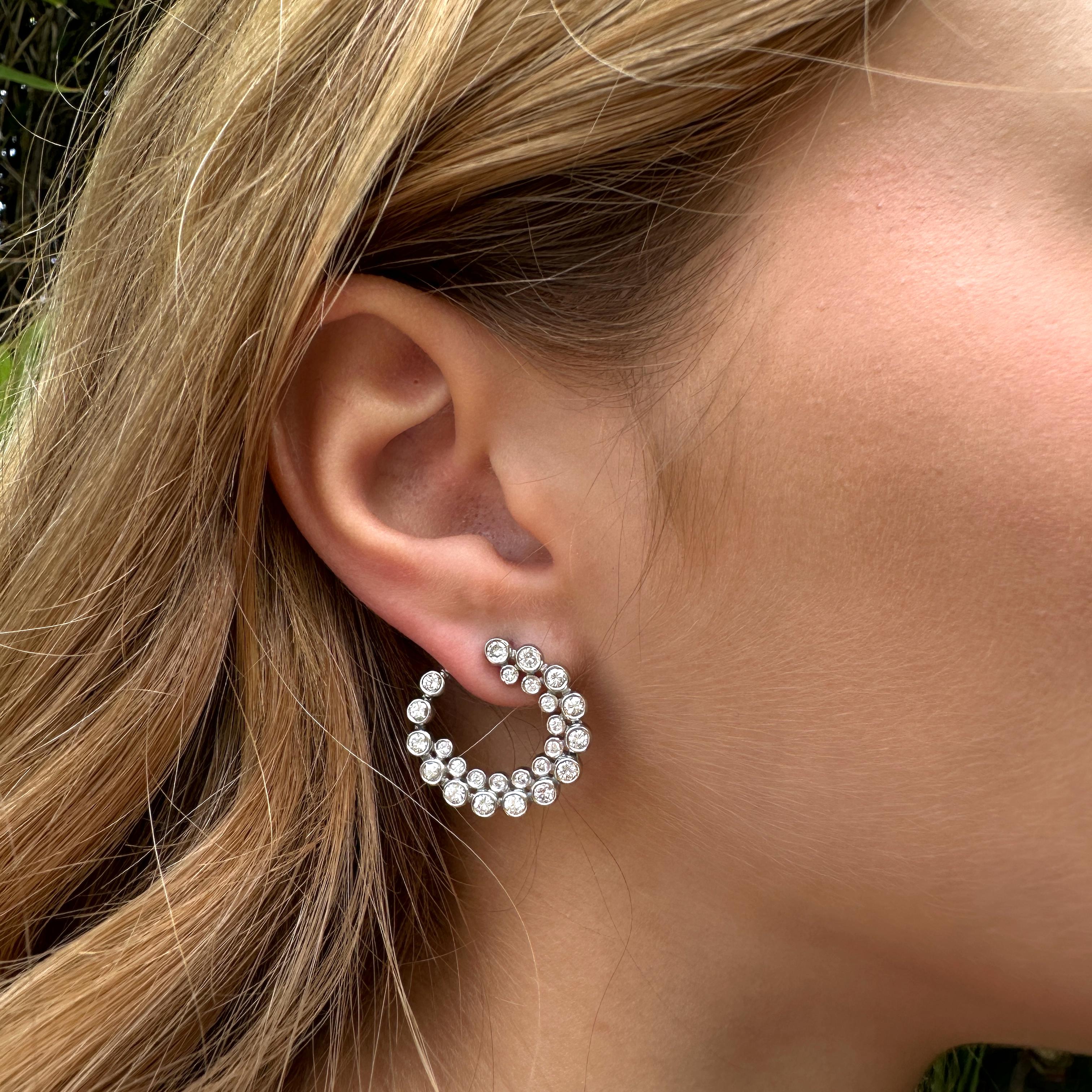 These fantastic new platinum earrings by Eytan Brandes present a spiral of diamonds with a shorter spiral of smaller diamonds nestled within.  The spiral drops slightly in elevation from top to tail, so the tail can be tucked behind your earlobe. 