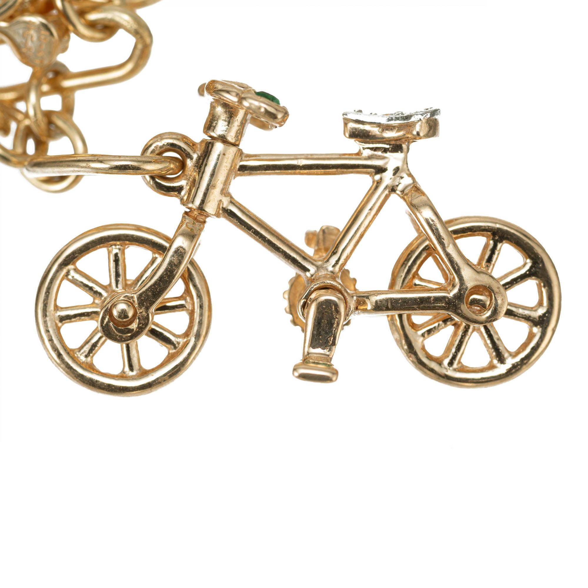 Round Cut .02 Carat Diamond Emerald Yellow Gold Bicycle Themed Charm Bracelet For Sale