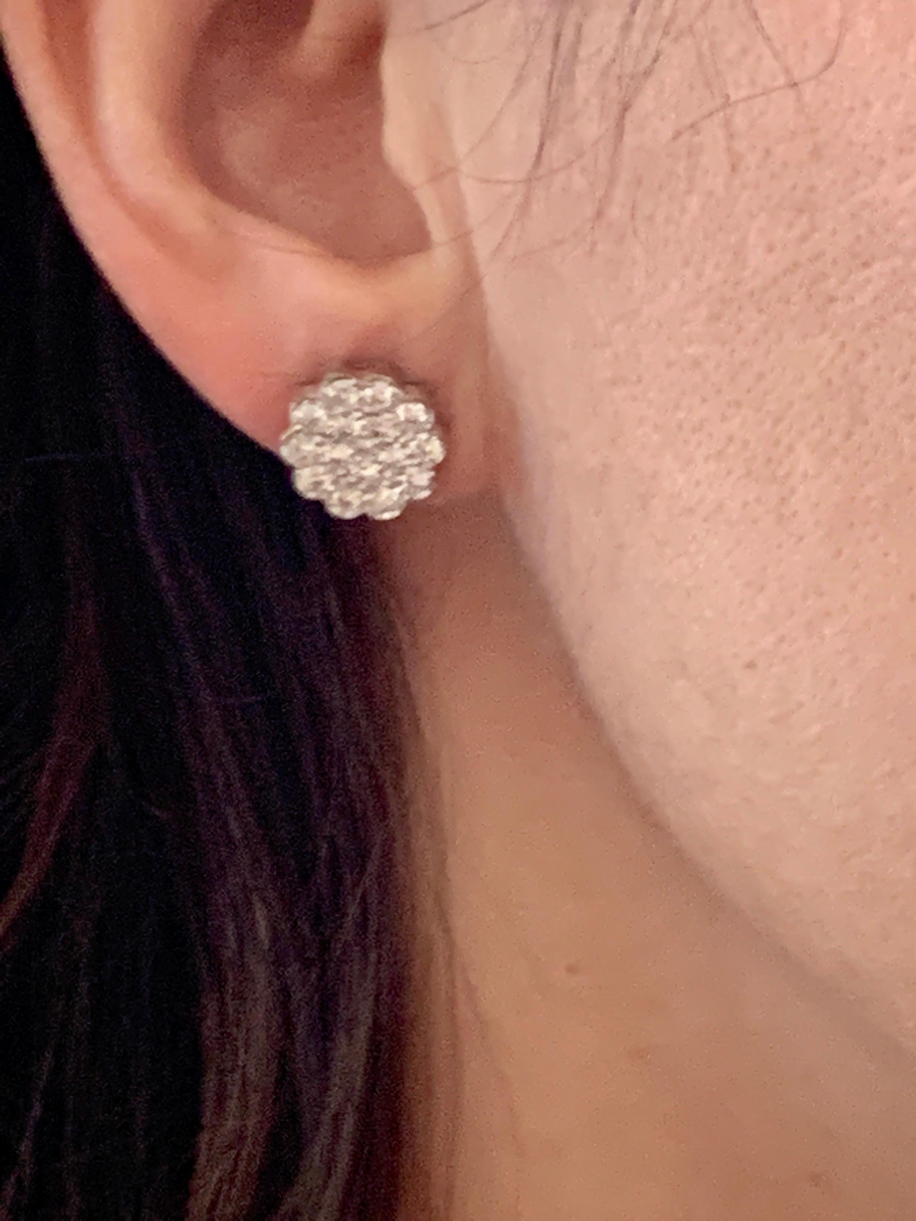 A sweet, shimmery style for any day of the week. These stud earrings blossom floral clusters of approximately 2  ct. of  round brilliant-cut diamonds. Set in 14 kt White gold. Post, diamond floral cluster stud earrings.
It's  a unique and playful