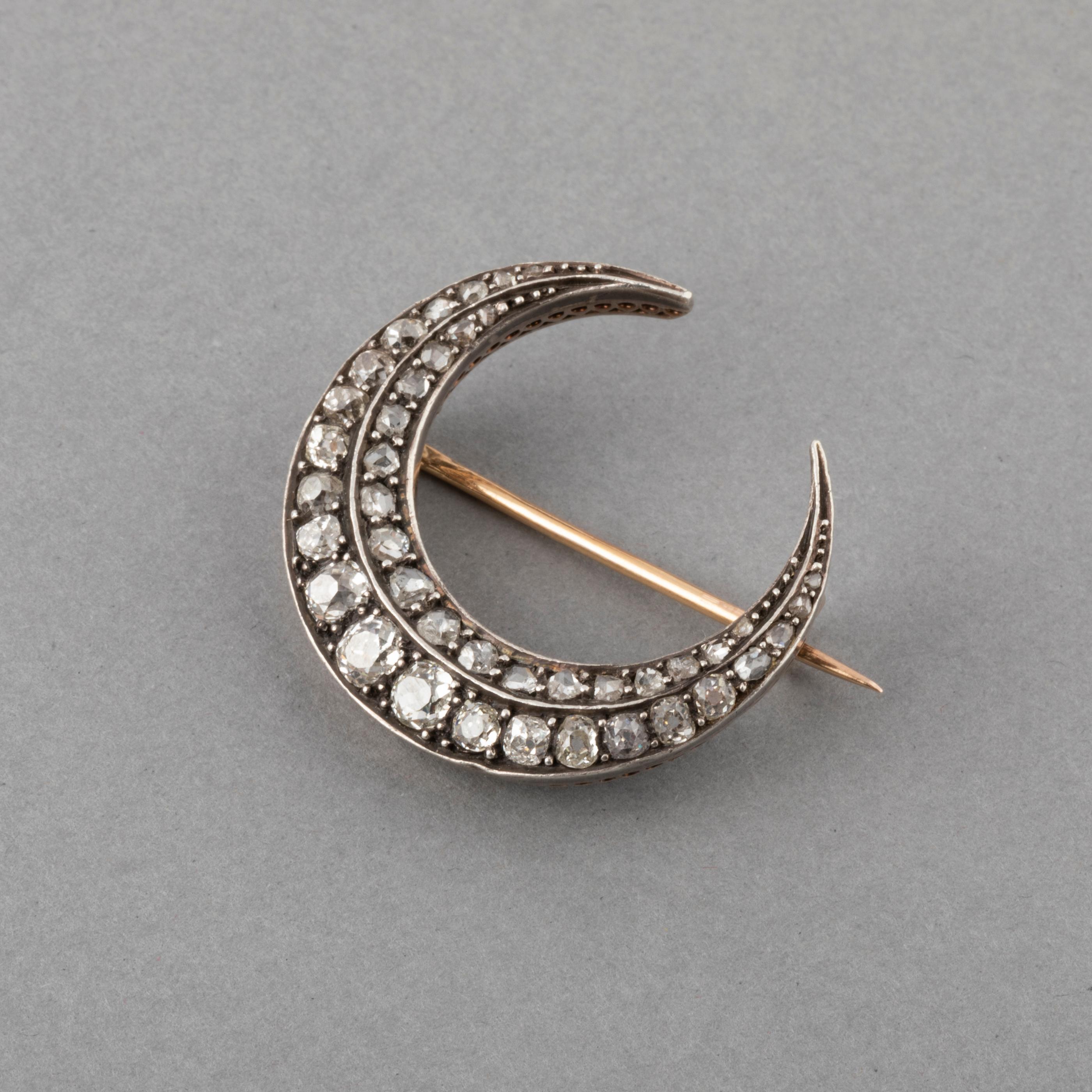 2 Carat Diamonds Antique French Crescent Brooch

Beautiful antique Crescent, made in France circa 1890. Made in rose gold 18k and silver. Mark gold: the owl. Mark for silver: the swan. 
The diamonds weights 2 carats at least. Old European cut and