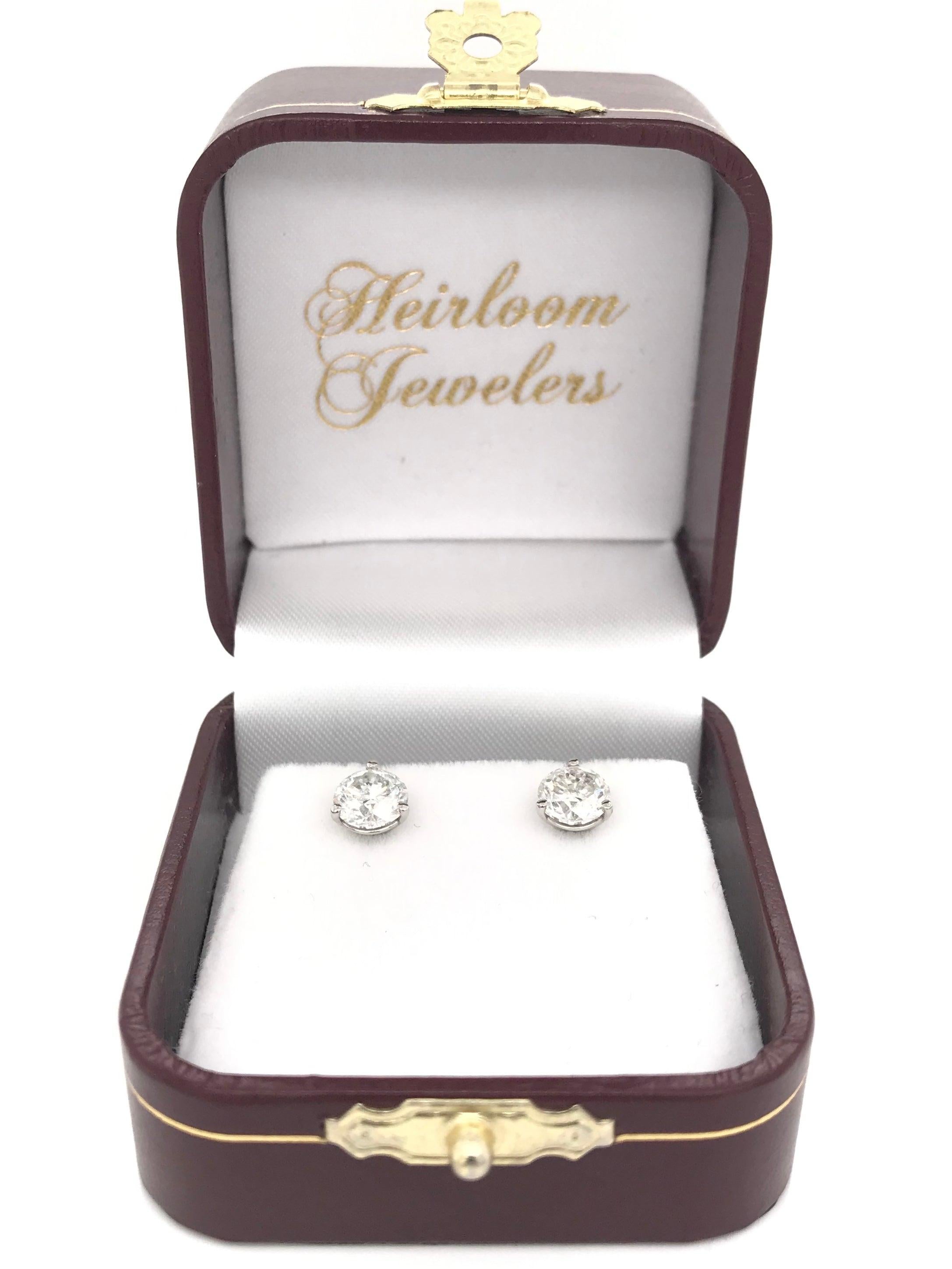 These contemporary style diamond earrings feature approximately 2 carats of diamonds; combined total weight. The settings are 14k white gold and are 