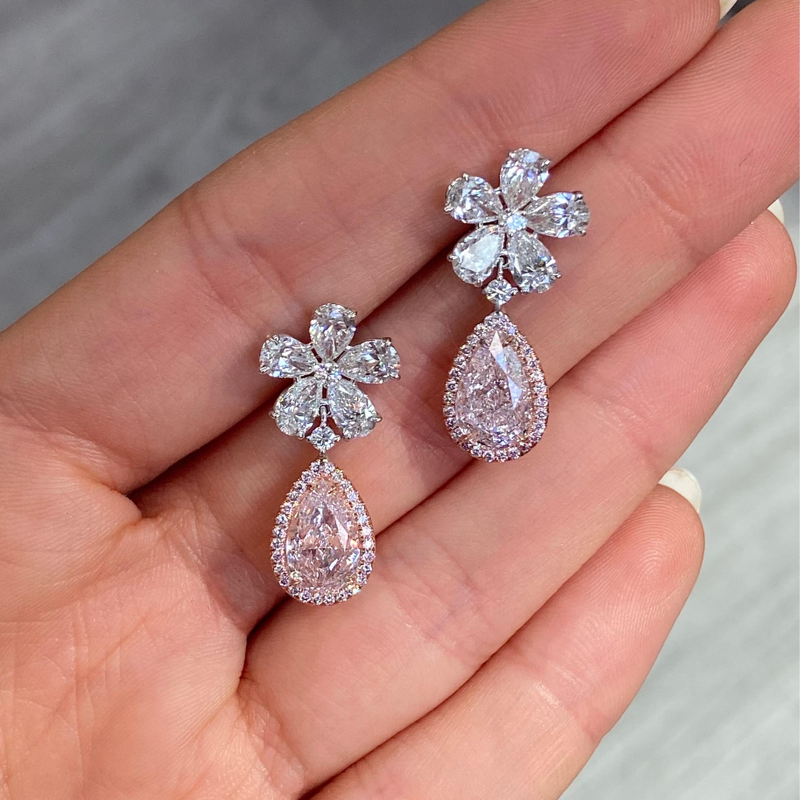 Step into a world of exquisite rarity with these breathtaking pink diamond earrings, a poetic fusion of elegance and craftsmanship. At the heart of each earring lies a luminous 2.02 and 2.22 carat light pink pear-shaped diamond — VS1 and VS2 clarity
