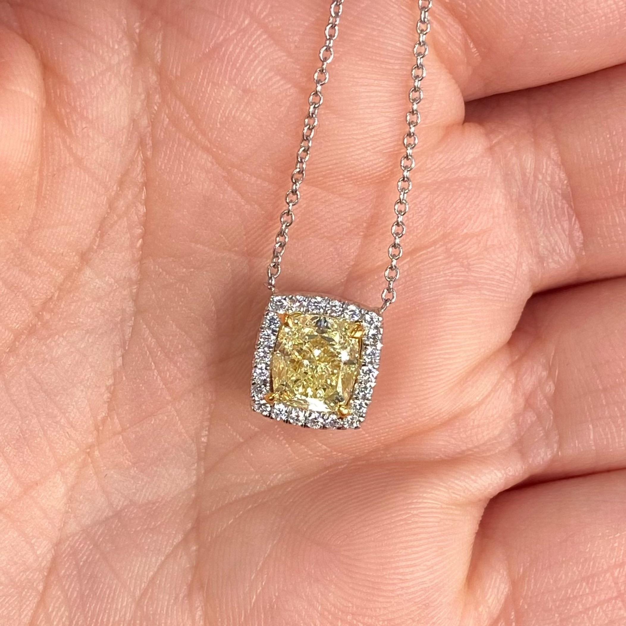 2.19 Carat Total Weight
2.00 Carat Center Diamond
Fancy Light Yellow
VS2 Clarity
GIA Certified Diamond
Excellent, Very Good Cutting
Medium Blue Fluorescence
Set in 18k Gold
Handmade in NYC
18 Inch chain

This piece can be viewed before purchase in