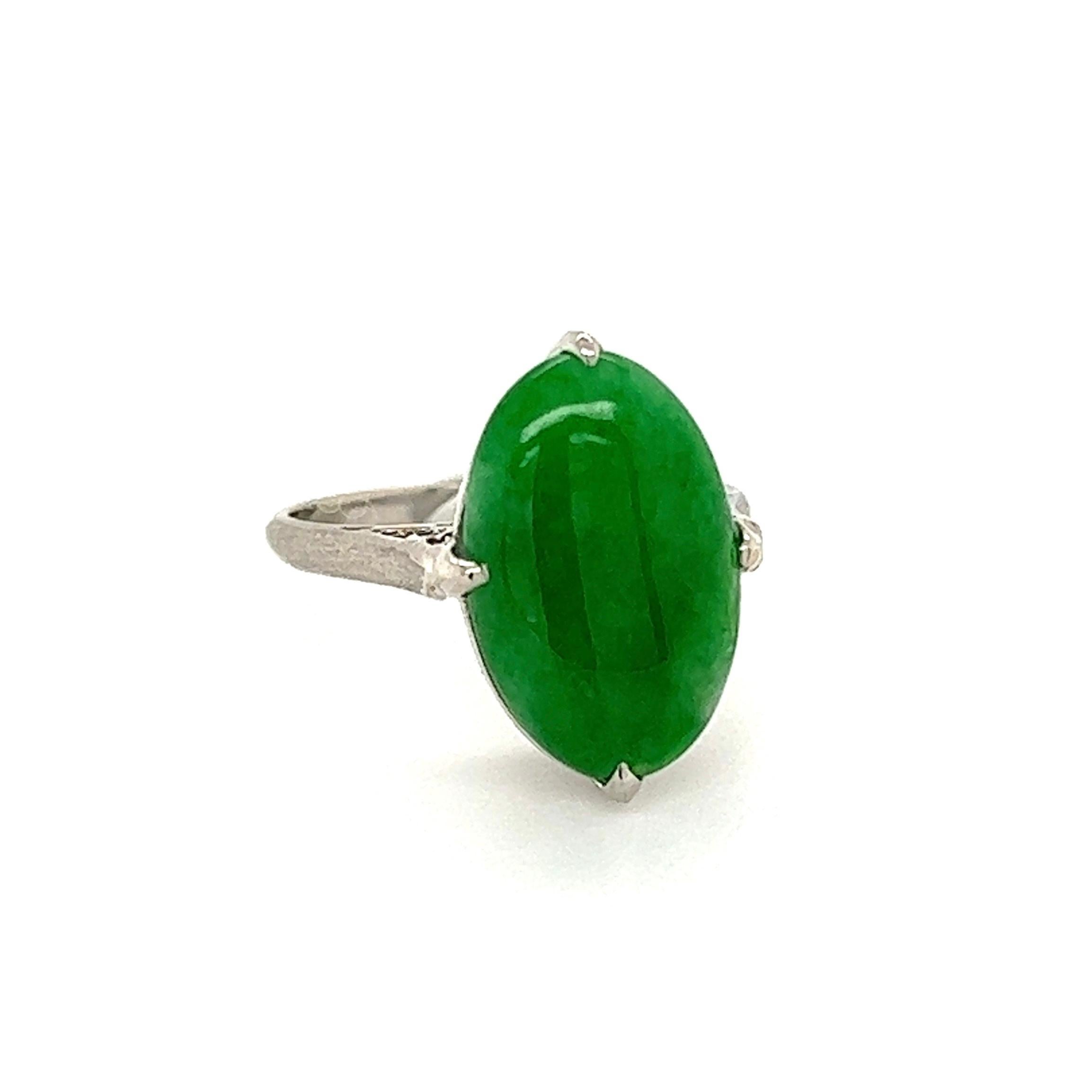 Simply Beautiful! Finely crafted Solitaire Cocktail Ring, center Hand set with a securely nestled 2 Carat Oval Cabochon Jadeite Jade. Hand crafted Platinum mounting. Ring size 4, we offer ring resizing. Approx. Dimensions: 0.90: L x 0.65” W x 0.58”