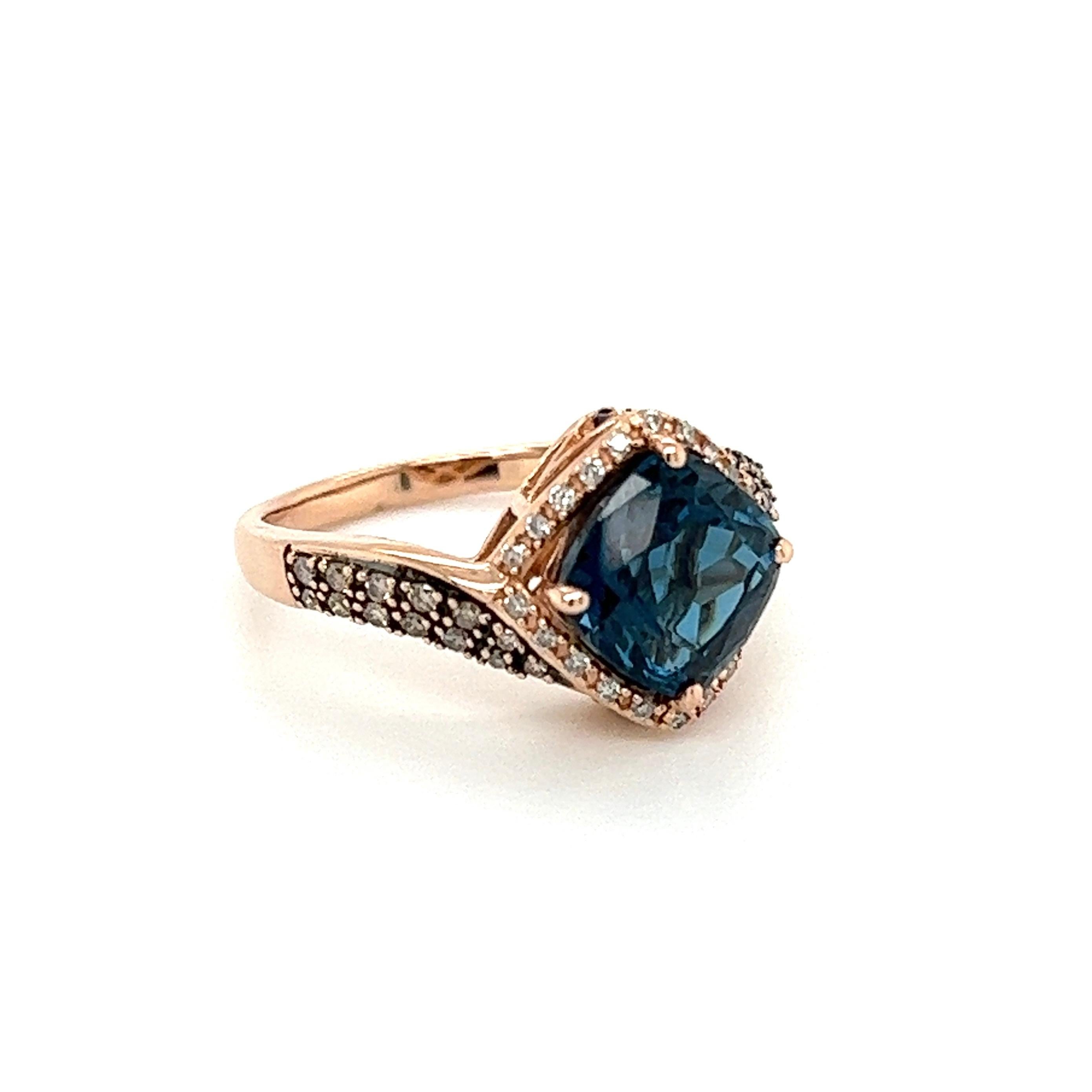 Simply Beautiful! Finely detailed London Blue Topaz and Diamond Gold Cocktail Ring. Centering a securely nestled London Blue Topaz, approx. 2 Carat, surrounded by Champagne and White Diamonds, approx. 0.55tcw. Hand crafted 14K Rose Gold mounting.