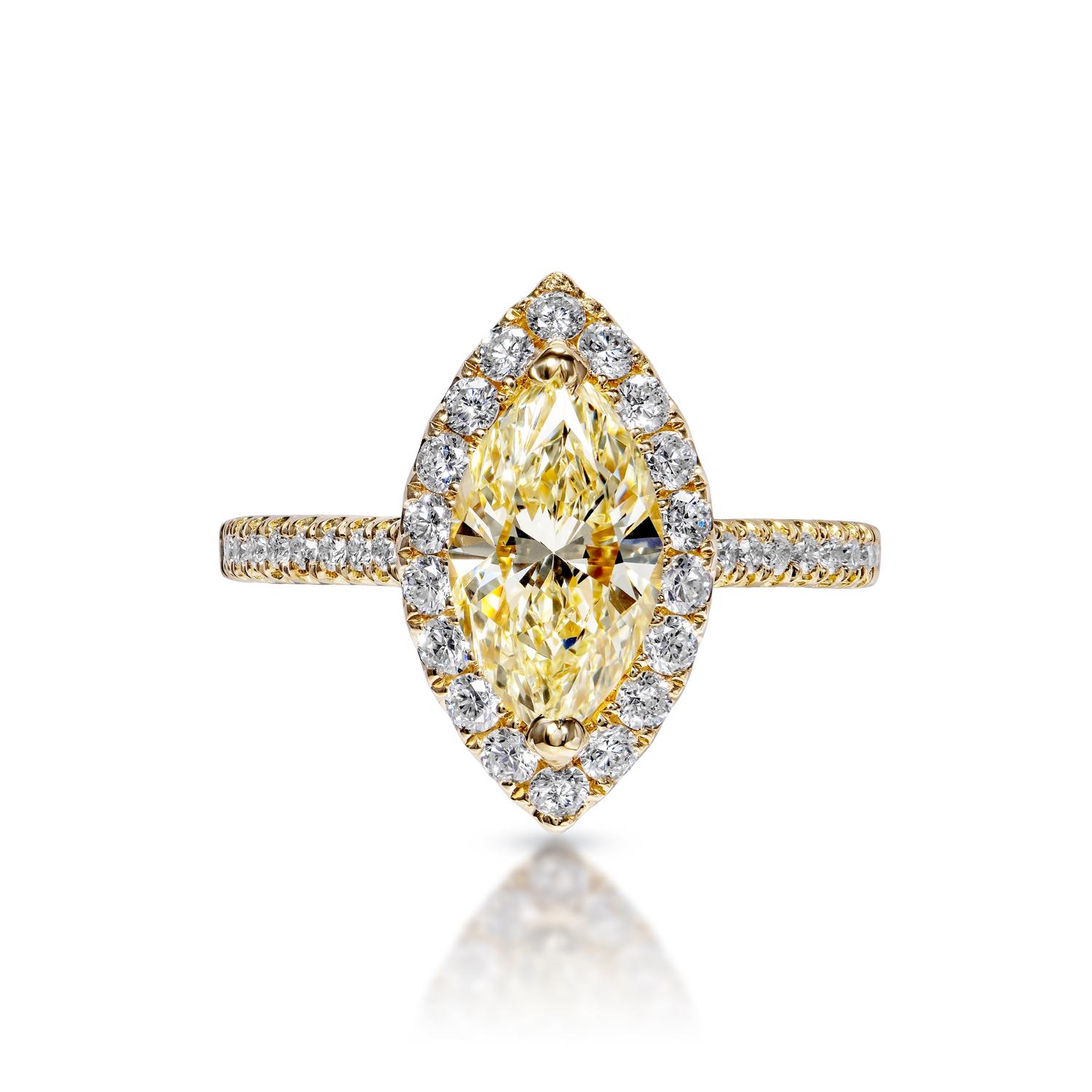 Earth Mined Center Diamond:
Carat Weight: 1.51 Carats
Color: Yellow Diamond
Clarity: VVS2
Style: Marquise Cut

Carat Weight: 0.56 Carats
Shape: Round Brilliant Cut
Setting: Sidestone & Halo 
Metal: 18 Karat Yellow Gold

Total Carat Weight: 2.06