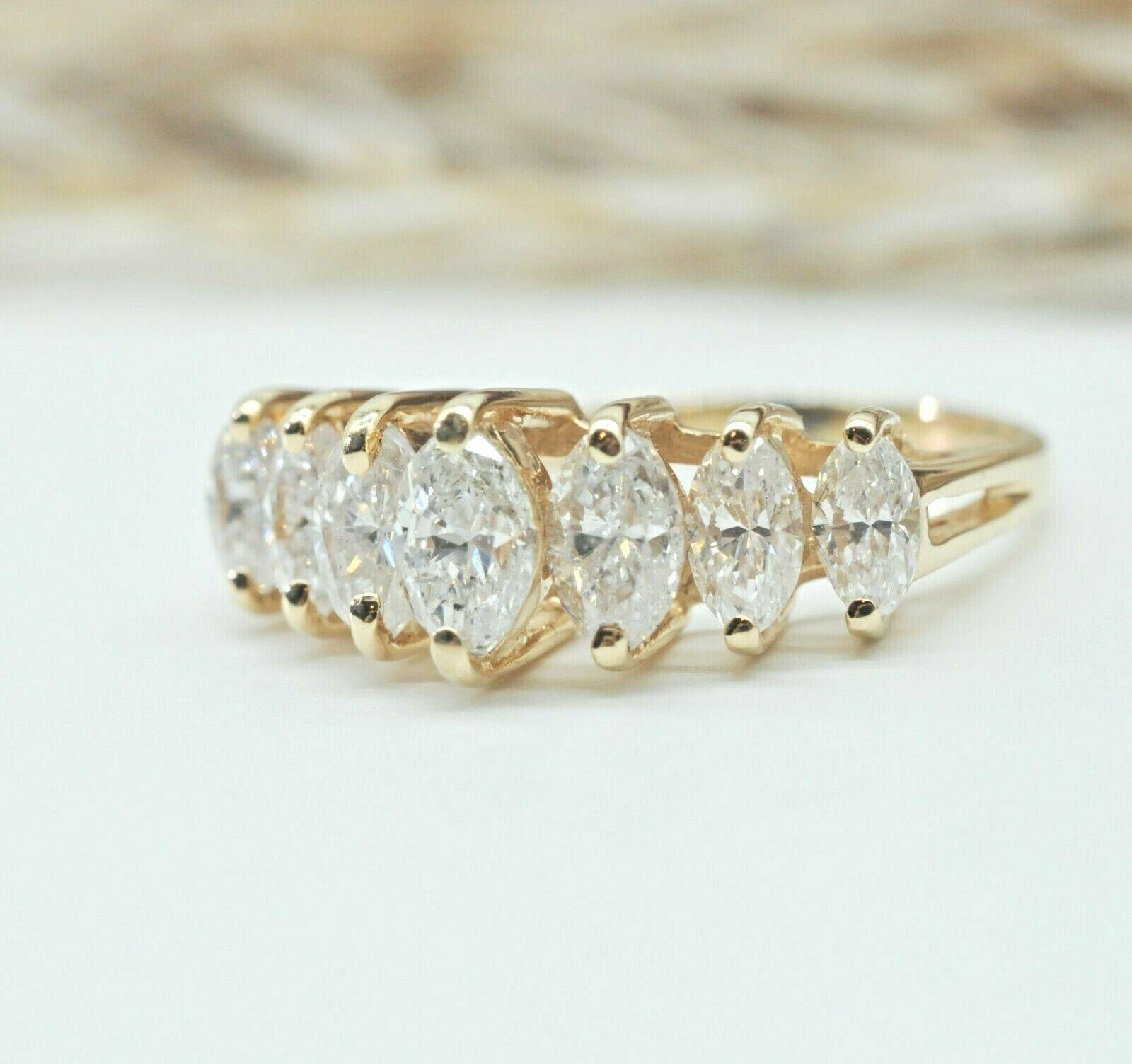 2.00 CARAT MARQUISE DIAMONDS BAND RING IN 
14K YELLOW GOLD 6.75US
Specifications:
    main stone: MARQUISE DIAMOND
    DIAMONDS: 7 PCS
    carat total weight: 2.00 CARAT TOTAL WEIGHT
    color: F
    clarity: SI1
    brand: NONE
    metal: 14K