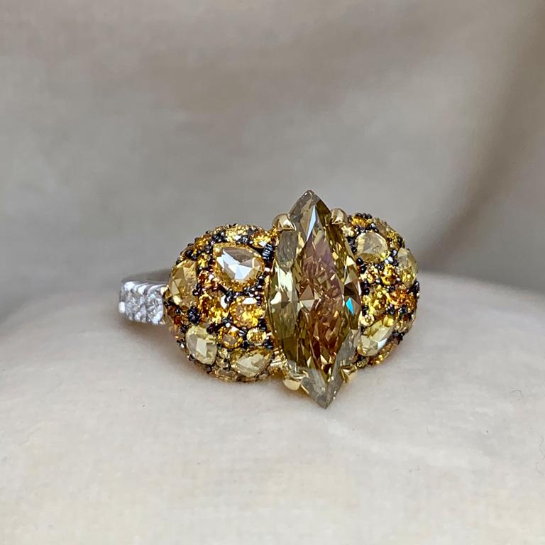 One of a kind ring in 18K Yellow & white gold 7 g. Set with a Fancy greenish brown, 2 ct. Marquise shape diamond centerstone, pave set Fancy cognac brilliant-cut diamonds 0,745 ct. Fancy yellow rose-cut diamonds 0,62 ct., white DEGVVS brilliant-cut