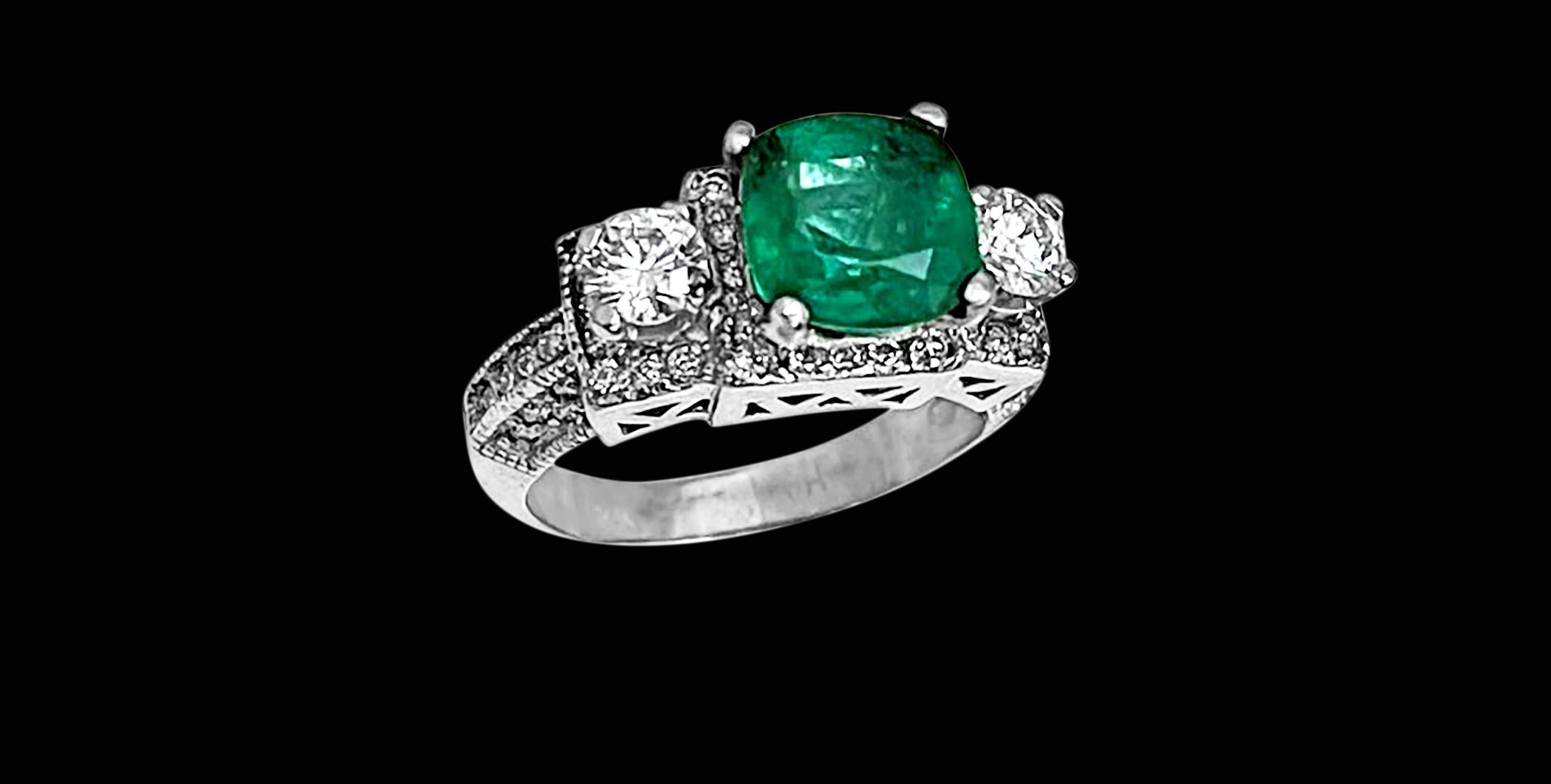 A classic, Cocktail ring 
 2 Carat Natural Cushion Cut Emerald & Diamond Ring 14 Karat White Gold Size 6
Intense green color, Beautiful stone with shine and luster  but has small  inclusions as all natural emeralds have inclusions.  
They have black