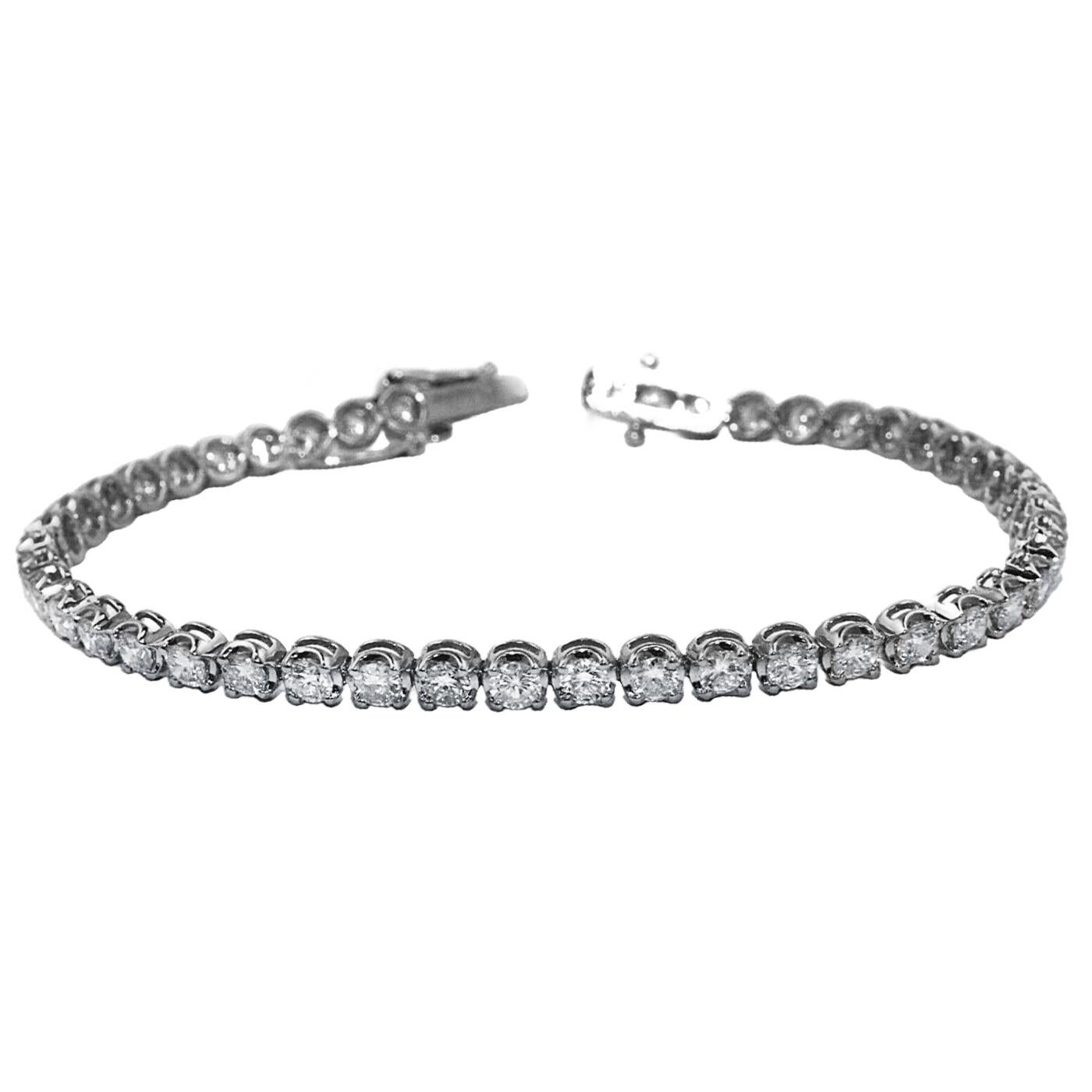 This spectacular 2ct tennis bracelet is crafted from 14K white gold and features 50 round-cut natural diamonds. The ultimate gift idea. The total diamond weight of this bracelet is 2ct. The diamonds have VS clarity and H color. This diamond bracelet