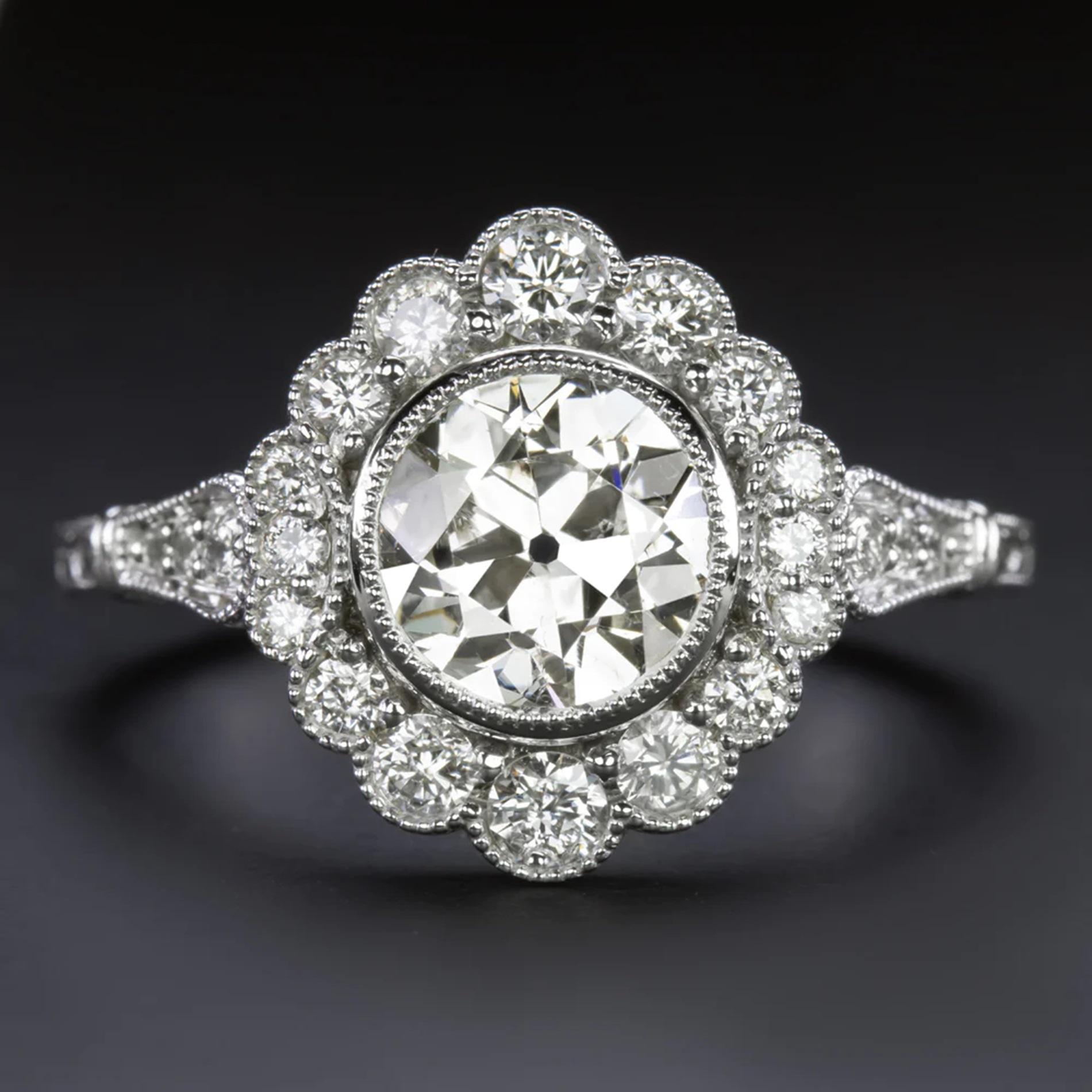 This vintage diamond ring commands attention with its impressive size and a beautifully detailed filigree setting adorned with diamonds. The generous 2-carat round brilliant cut center diamond captivates with its eye-catching size and dazzling