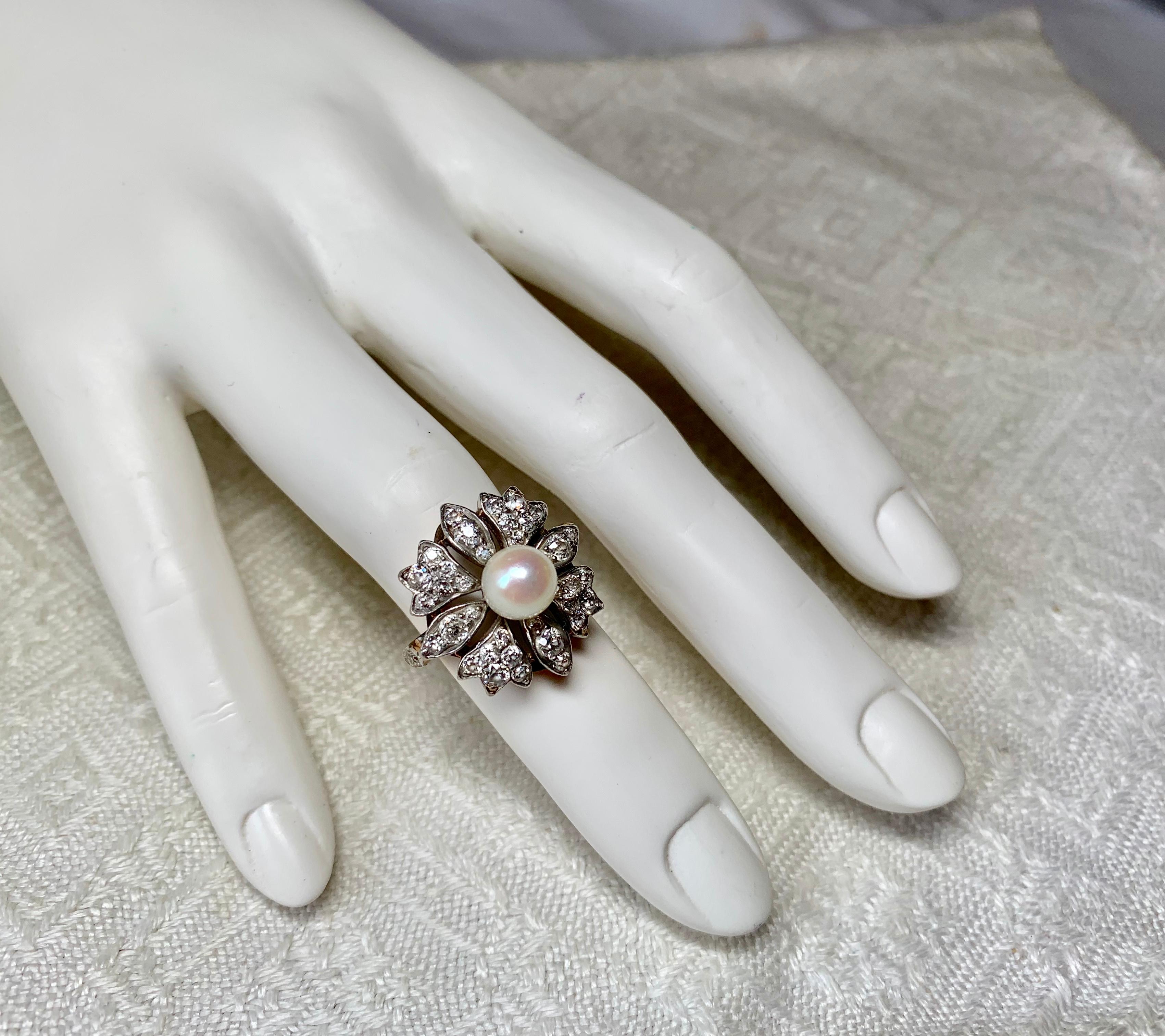 This is a stunning antique Victorian two carat Old Mine Cut Diamond ring with a central 7MM Pearl.  The jewels are set in Platinum atop 14 Karat Gold in a Flower Motif of great beauty.  The flower is set with 38 gorgeous Old Mine Cut Diamonds. 