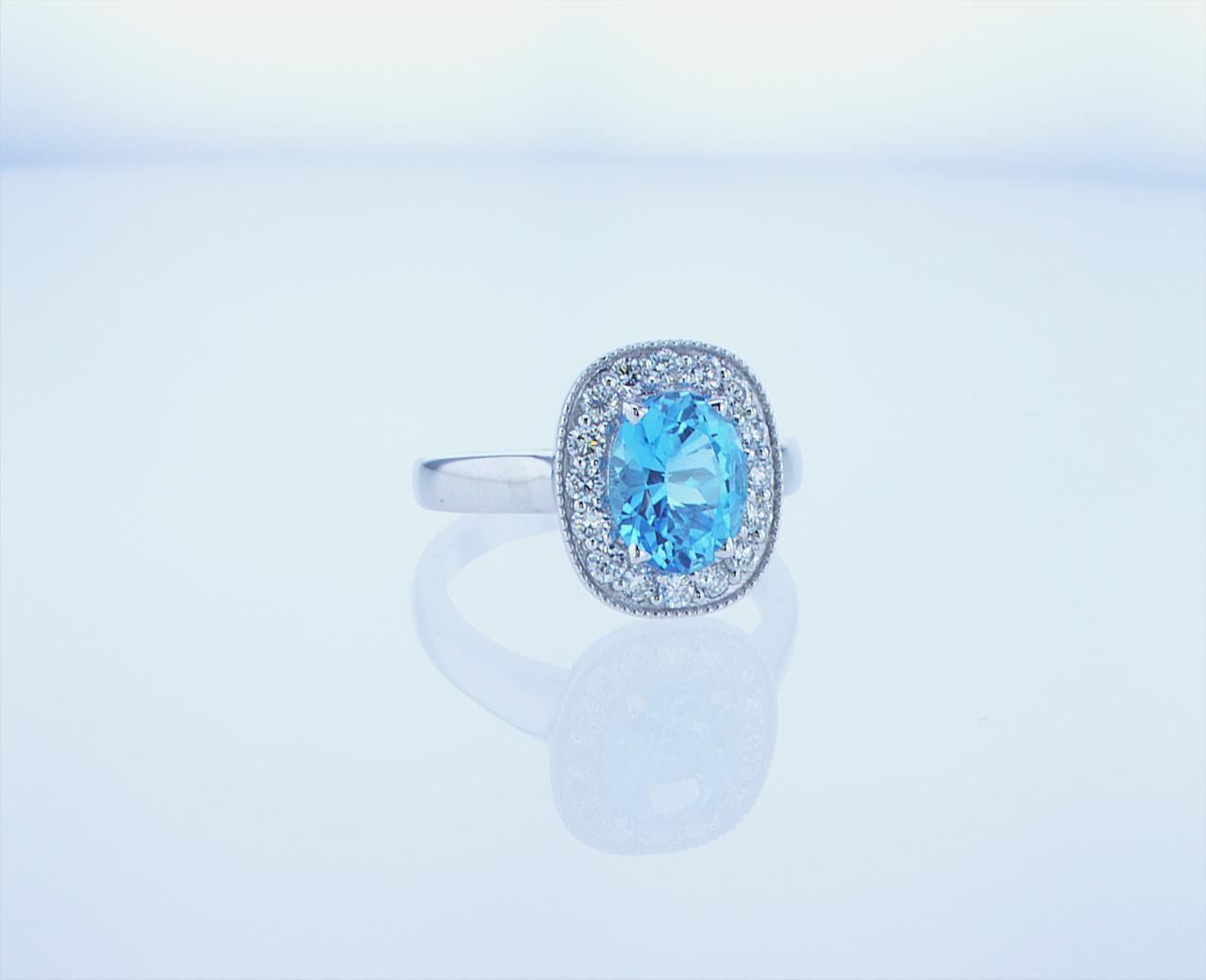 Oval Cut 2 Carat Oval Blue Topaz Ring with Half Carat of Accent Diamonds For Sale