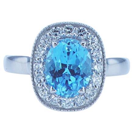 2 Carat Oval Blue Topaz Ring with Half Carat of Accent Diamonds For Sale