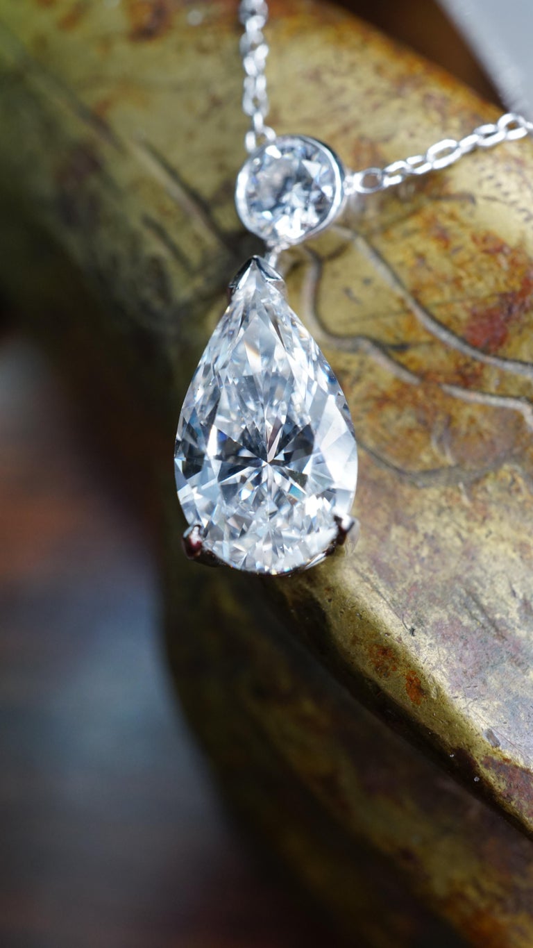 2 carat Lab Grown Pear shape diamond necklace with 5 bezel set Lab Grown diamonds set in 18K White gold. Lab Grown Pear Shape diamond center stone is E SI1. Lab Grown Brilliant diamonds are E-F SI1 . Total Carat weight = 3 ct. Total ring weight 3.25