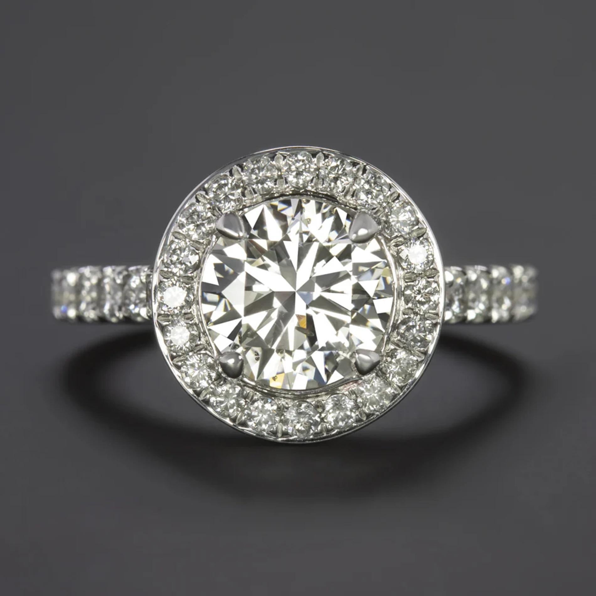 Dazzling 2.01ct Round Brilliant Engagement Ring: A Sparkling Masterpiece

Make a statement with this stunning engagement ring, featuring a substantial 2.01ct round brilliant cut diamond at its center. Surrounded by a glittering diamond halo and a