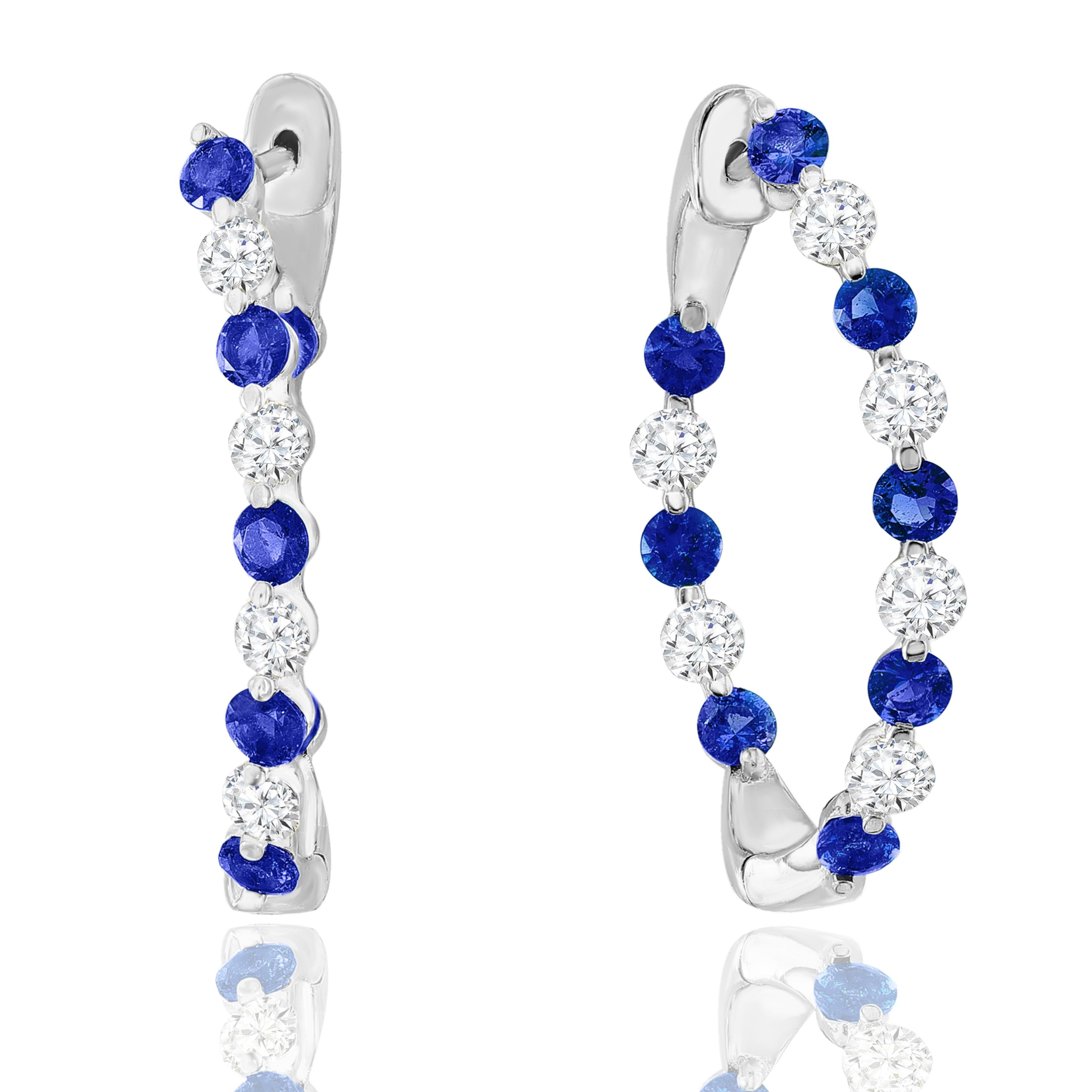 A chic and fashionable pair of hoop earrings showcasing brilliant-cut 16-round Blue Sapphires alternating with diamonds, set in 14k white gold. 12 Round diamonds weigh 1.15 carats in total and 16 Blue Sapphires weigh 2 carats in total. A beautiful