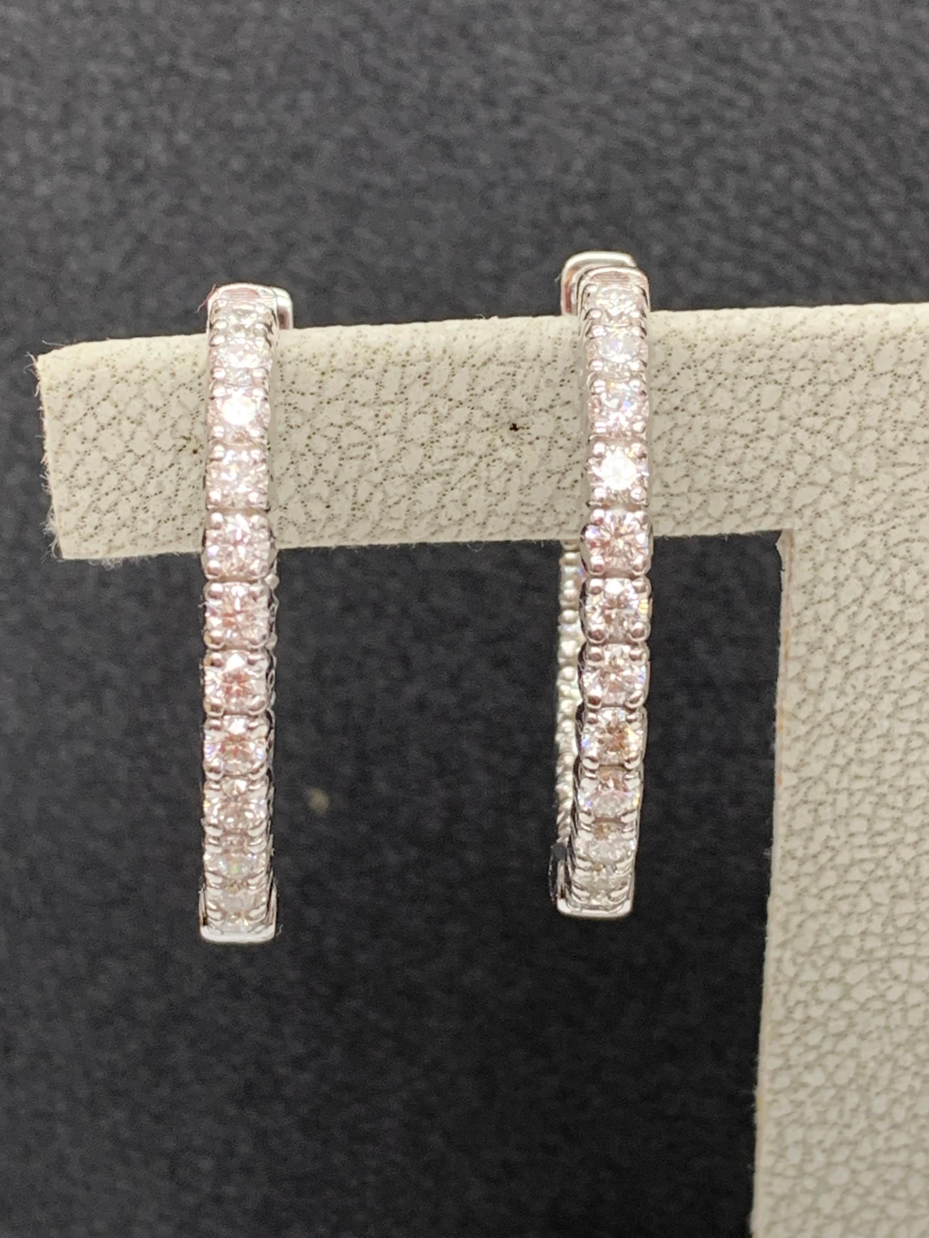 A chic and fashionable pair of hoop earrings showcasing round diamonds, set in 14k white gold.  40 Round diamonds weigh 2 carats in total. A beautiful piece of jewelry.
All diamonds are GH color SI1 Clarity.
Style is available in different price