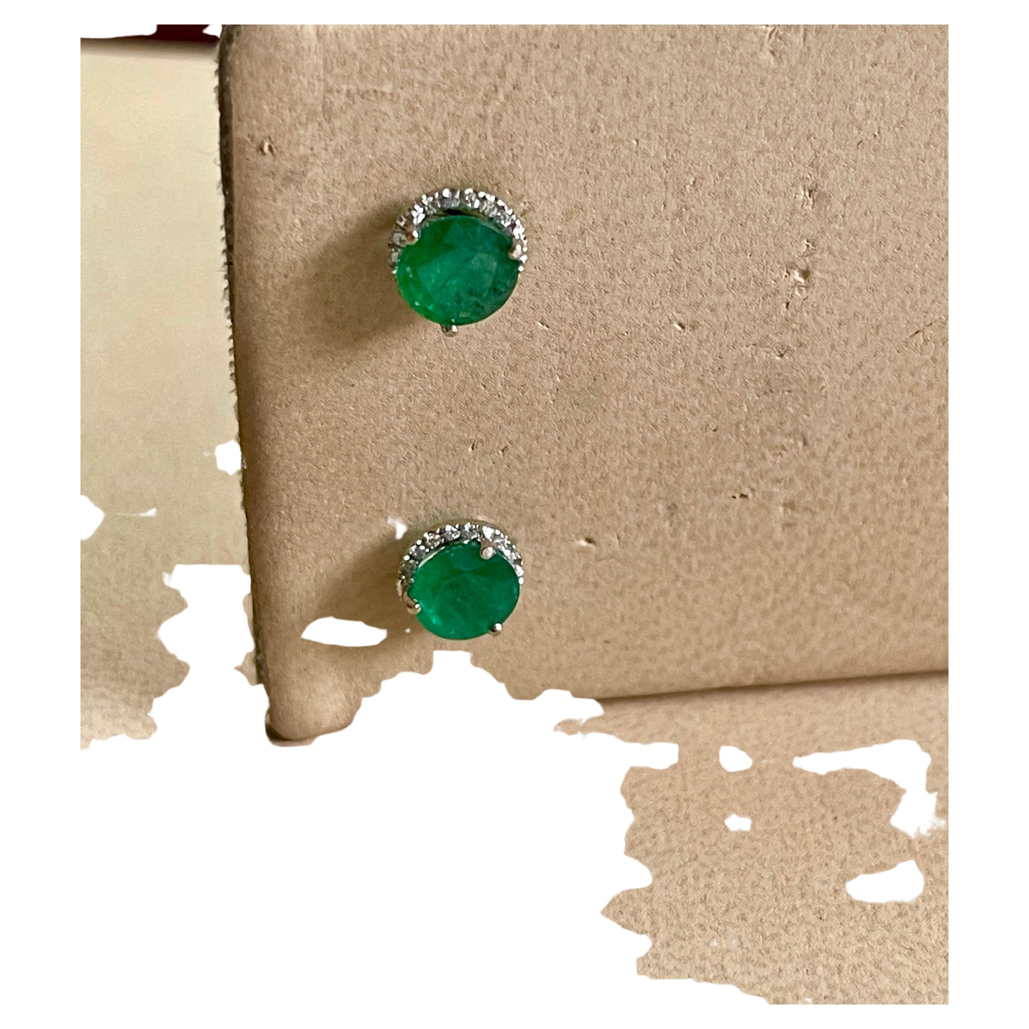 2 Carat Round Natural Emerald & Diamond Stud Post Earrings 14 Karat White Gold
This luxurious pair of Emerald  halo stud earrings is designed in 14K White   gold. The Round Emeralds are surrounded by a dazzling halo of round diamonds.
Round  Natural