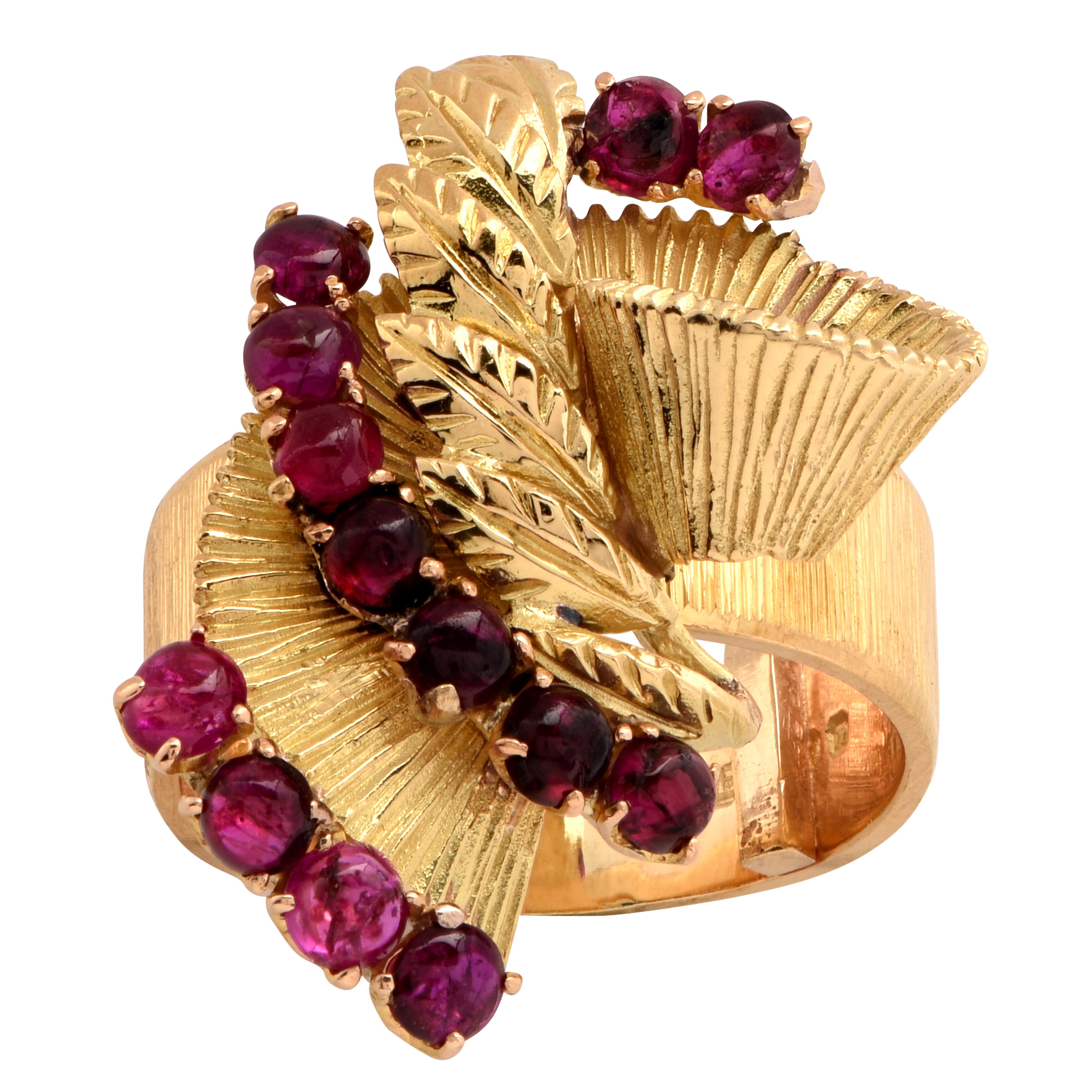 Stunning ring crafted in 18 karat yellow gold ring featuring 13 cabochon rubies weighing approximately 2 carats total. This work of art is rich in color and texture. The face of the ring measures 30.4mm in length and 24.85mm at its widest point. The