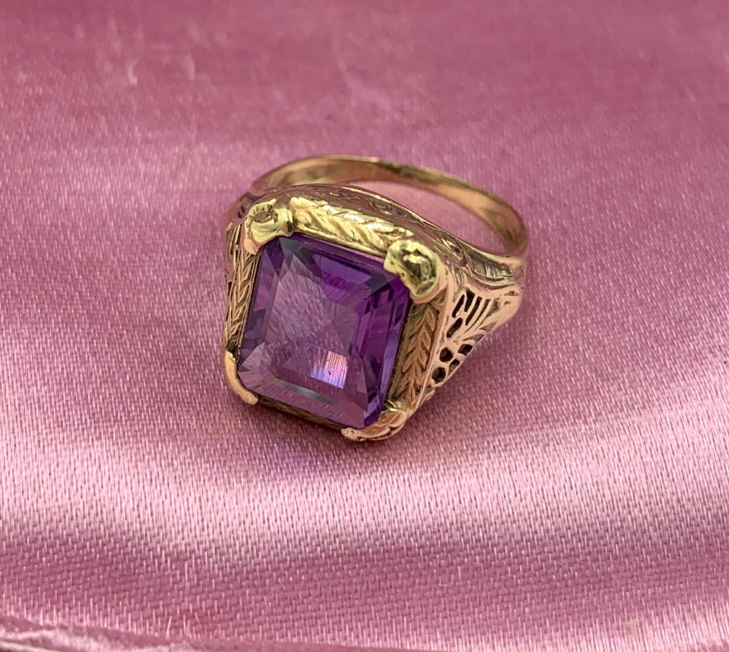 A stunning Antique Ring with a beautiful 2.2 Carat Siberian Amethyst set in a lovely open work setting in 14 Karat Yellow Gold.  The rectangular faceted Amethyst gem is vivid royal purple and is just a dream cut and color.  The gem is set in a