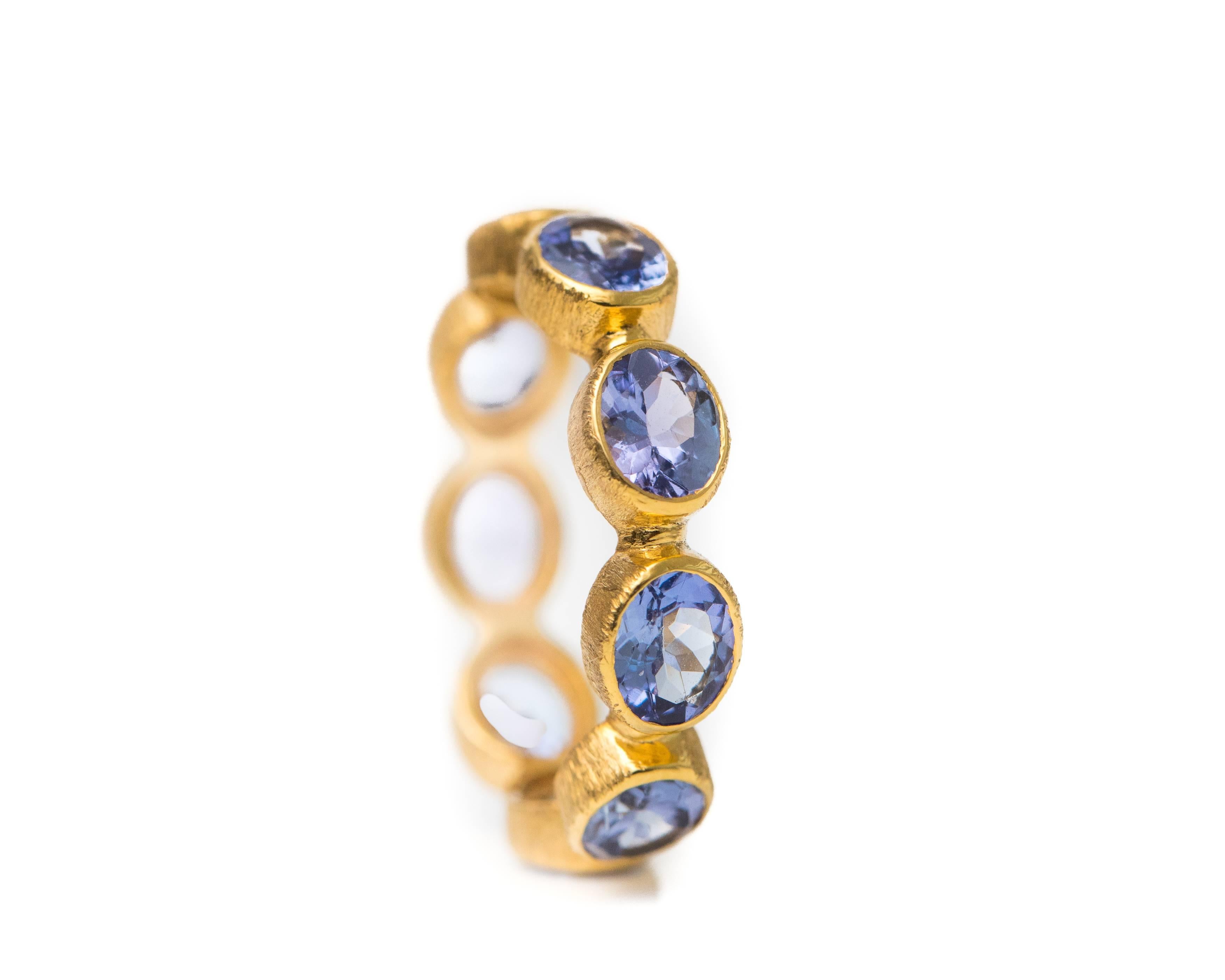 Oval Cut 2 Carat Tanzanite and 18 Karat Yellow Gold Eternity Band For Sale