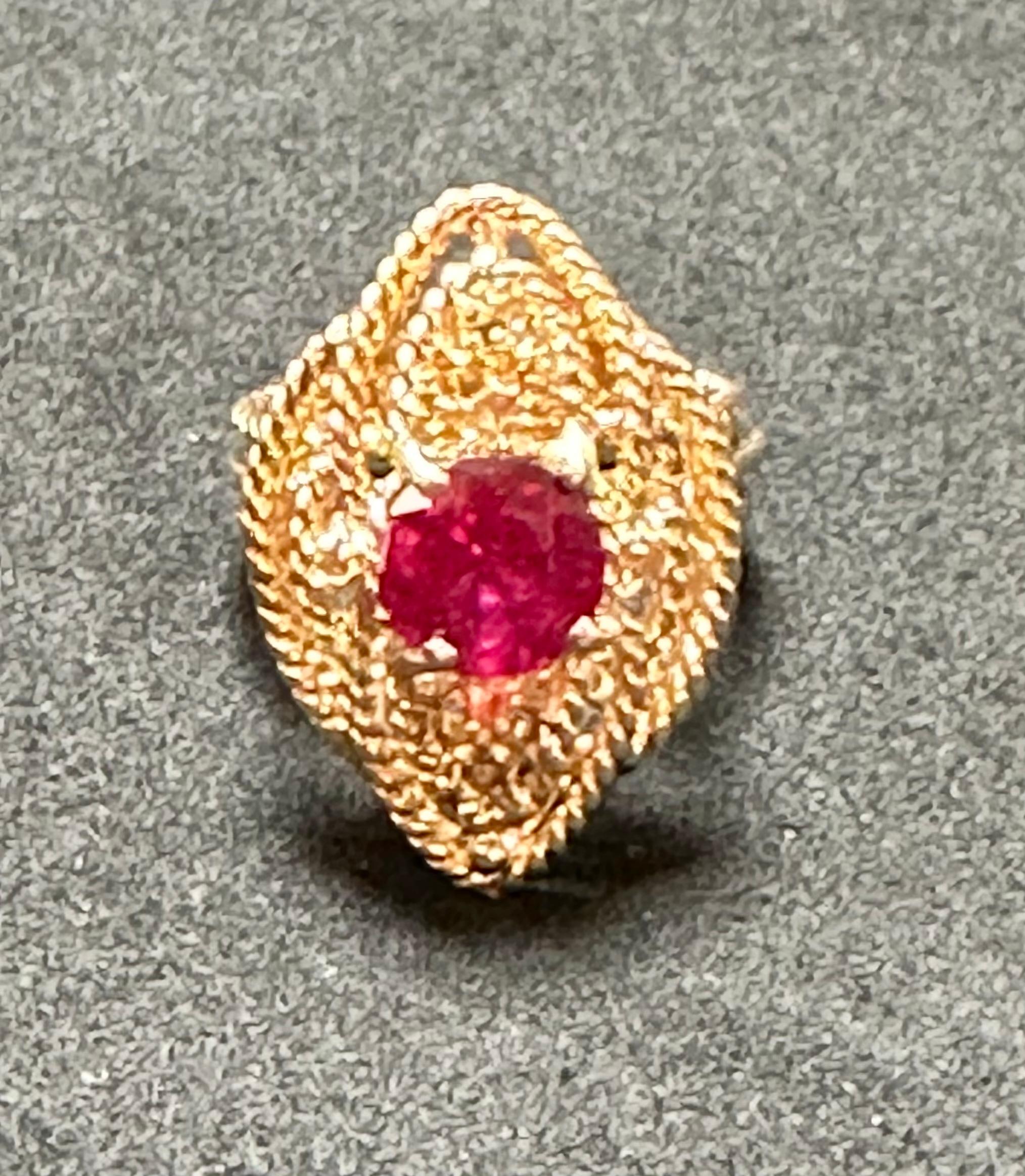 Introducing our exquisite Vintage 14 Karat Yellow Gold Cocktail Ring featuring a stunning 2 carat treated round ruby. This captivating ring showcases the ruby in a four-prong setting, enhancing its beauty and allowing the light to play off its