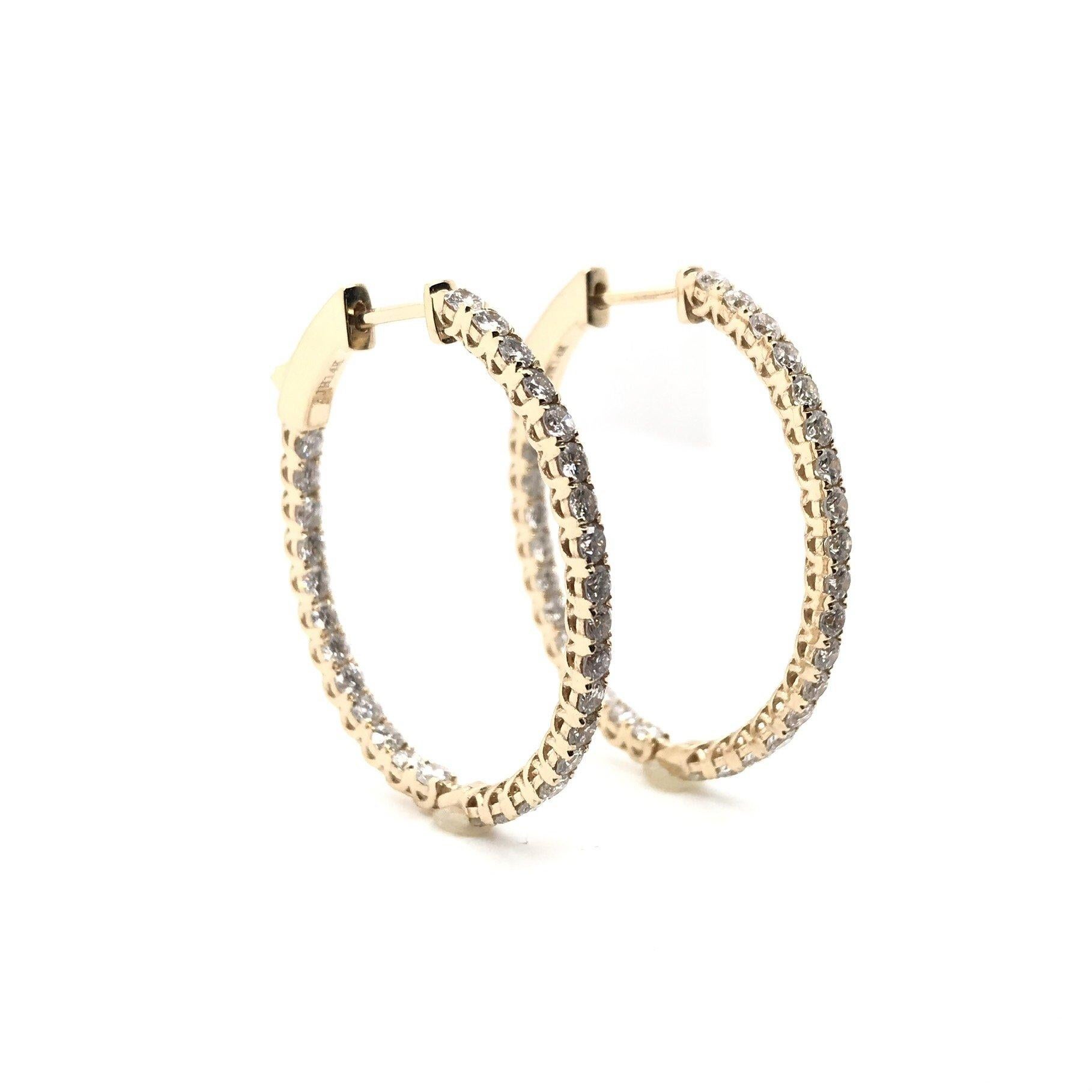 These stunning contemporary hoop earrings are new. Dazzling from every angle, these lovely diamond earrings feature approximately 2 full carats of diamonds; combined total weight. In and out style earrings feature diamonds set on the front facing