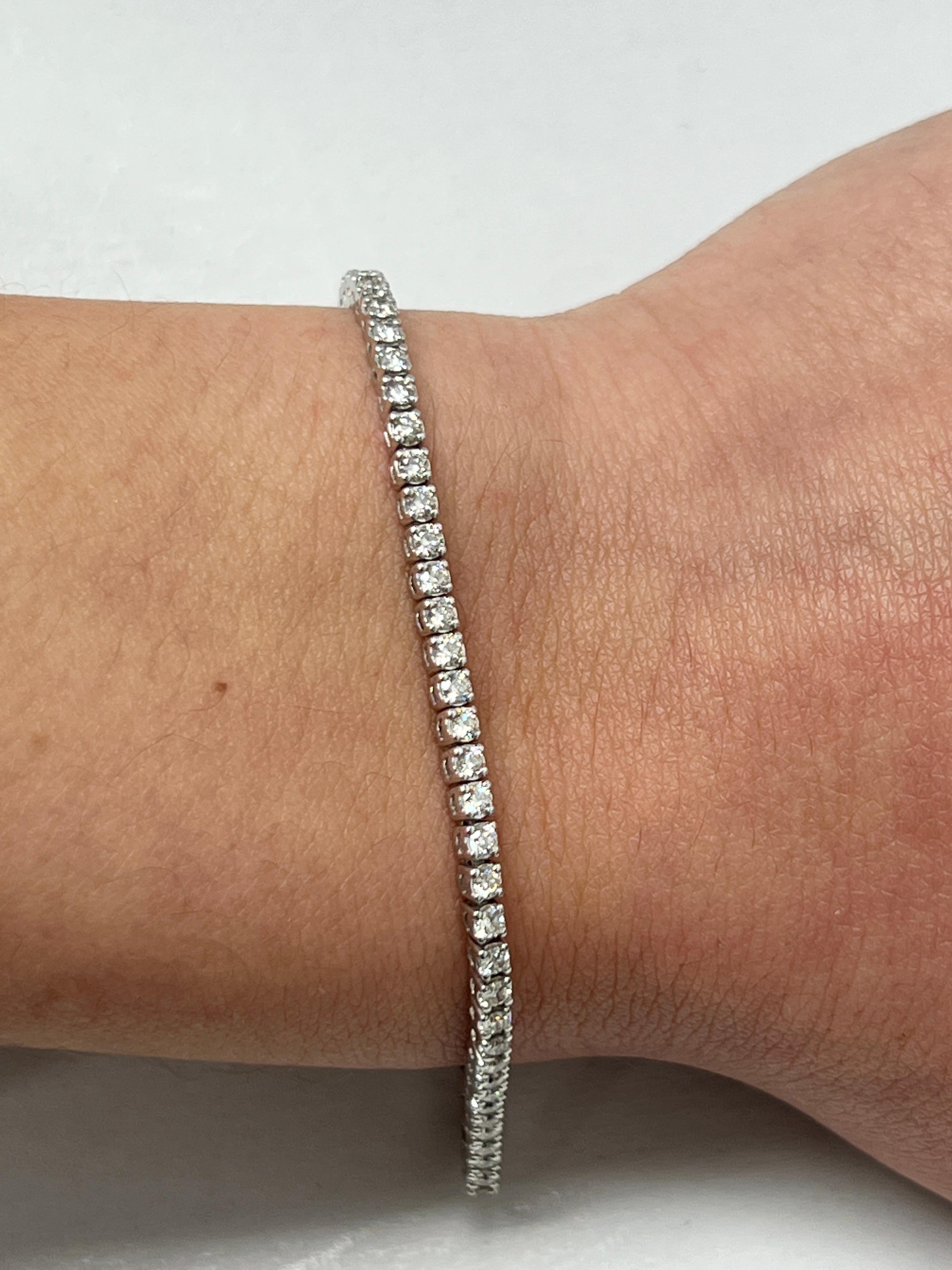 Fashion and glam are at the forefront with this exquisite diamond bracelet. This 14-karat white gold diamond bracelet is made from 8 grams of gold. The top is adorned with one row of I-J color, VS/SI clarity diamonds. This bracelet carries 77 round