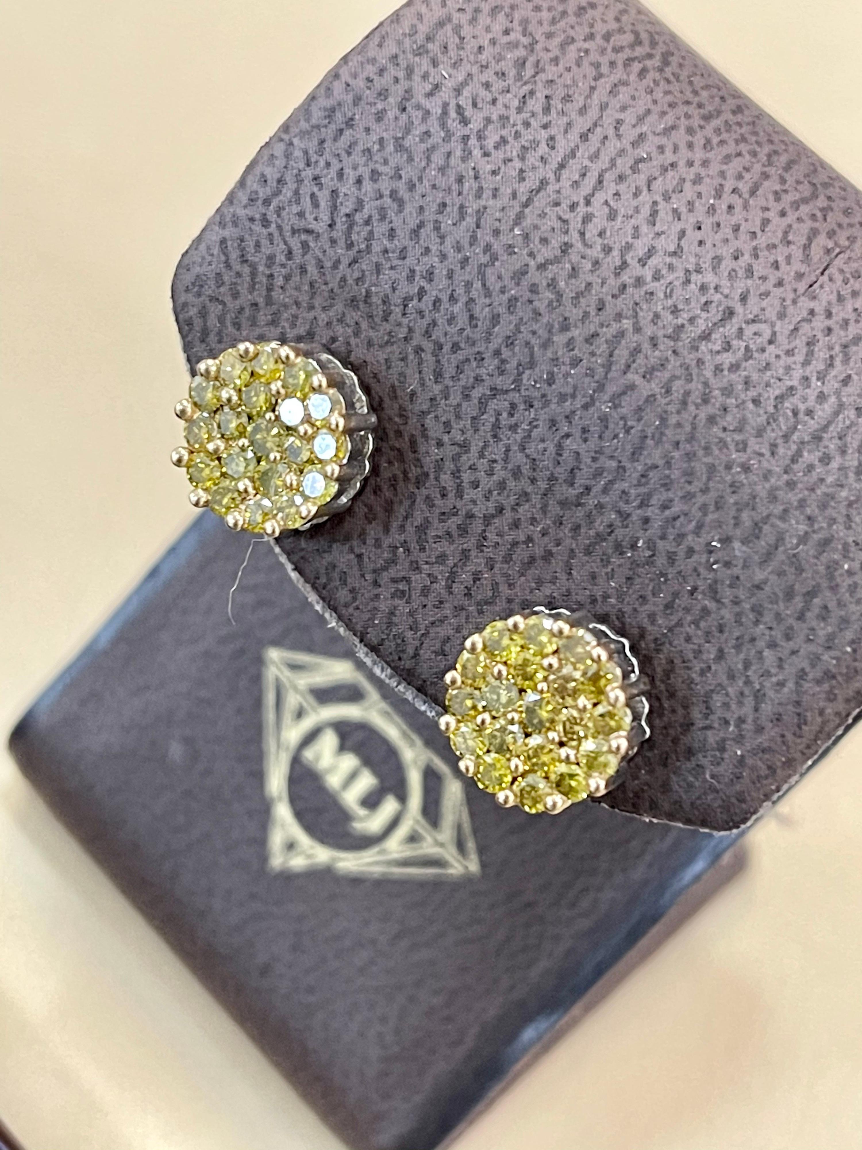 Approximately 2 Carat Yellow Diamond Floral Cluster Flower Stud Earrings 14 Karat White Gold
A sweet, shimmery style for any day of the week. These stud earrings blossom floral clusters of approximately 2  ct. of  round Yellow diamonds. Set in 14 kt