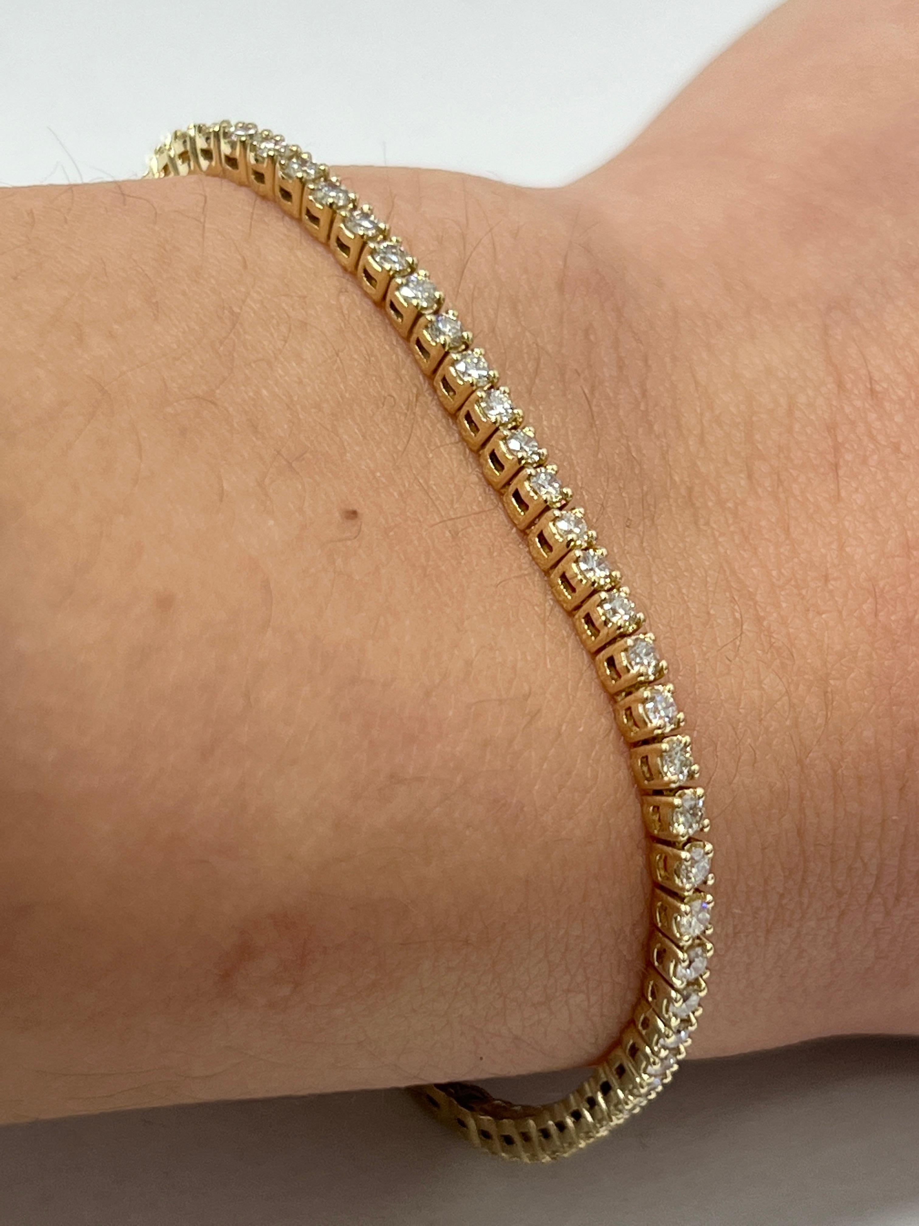 Fashion and glam are at the forefront with this exquisite diamond bracelet. This 14-karat yellow gold diamond bracelet is made from 8 grams of gold. The top is adorned with one row of I-J color, VS/SI clarity diamonds. This bracelet carries 77 round