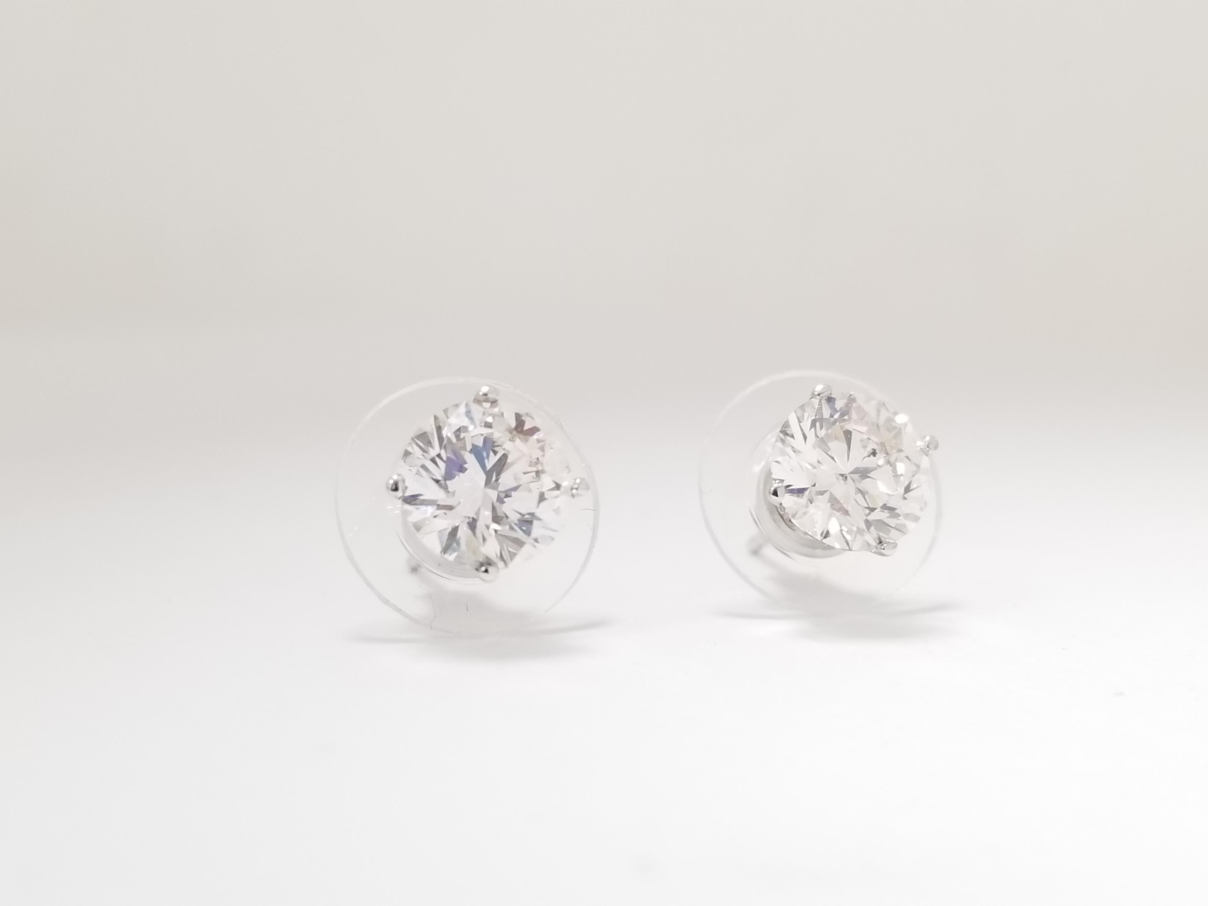 Natural Round Diamond Studs set in 4 prong push back 14k white gold 2 carats total weight. White face up, Clean. Average Color H-I, Clarity VS-SI.