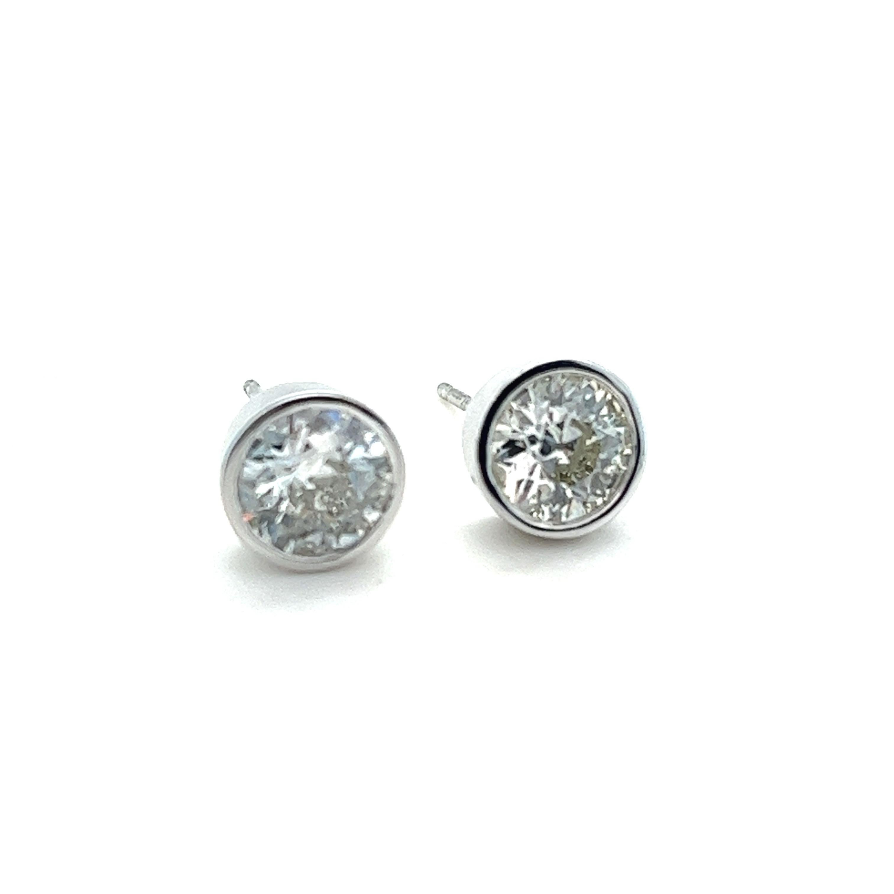 
Offered here is a mesmerizing pair of natural Old European cut diamonds elegantly set in platinum bezel stud earrings. These exquisite diamonds, originating from the Art Deco period, have been skillfully remounted in a contemporary design to