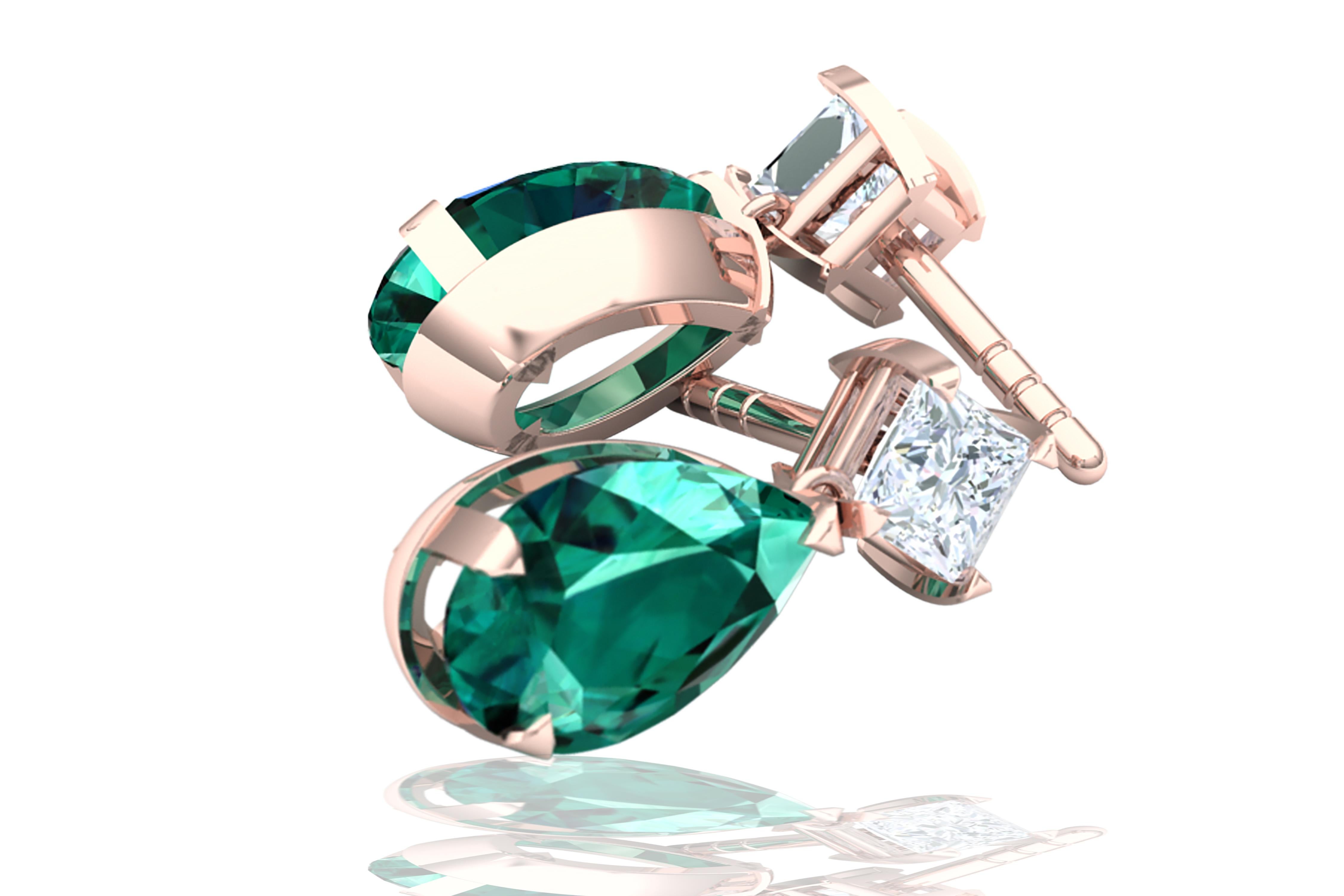 This impressive and timelessly designed tourmaline and diamond earrings have a stunning contrast between the deep green blue and white.  The tops of each earring is tipped with a .20ct Princess Cut Diamond that has a color and clarity of F-G VS-SI. 