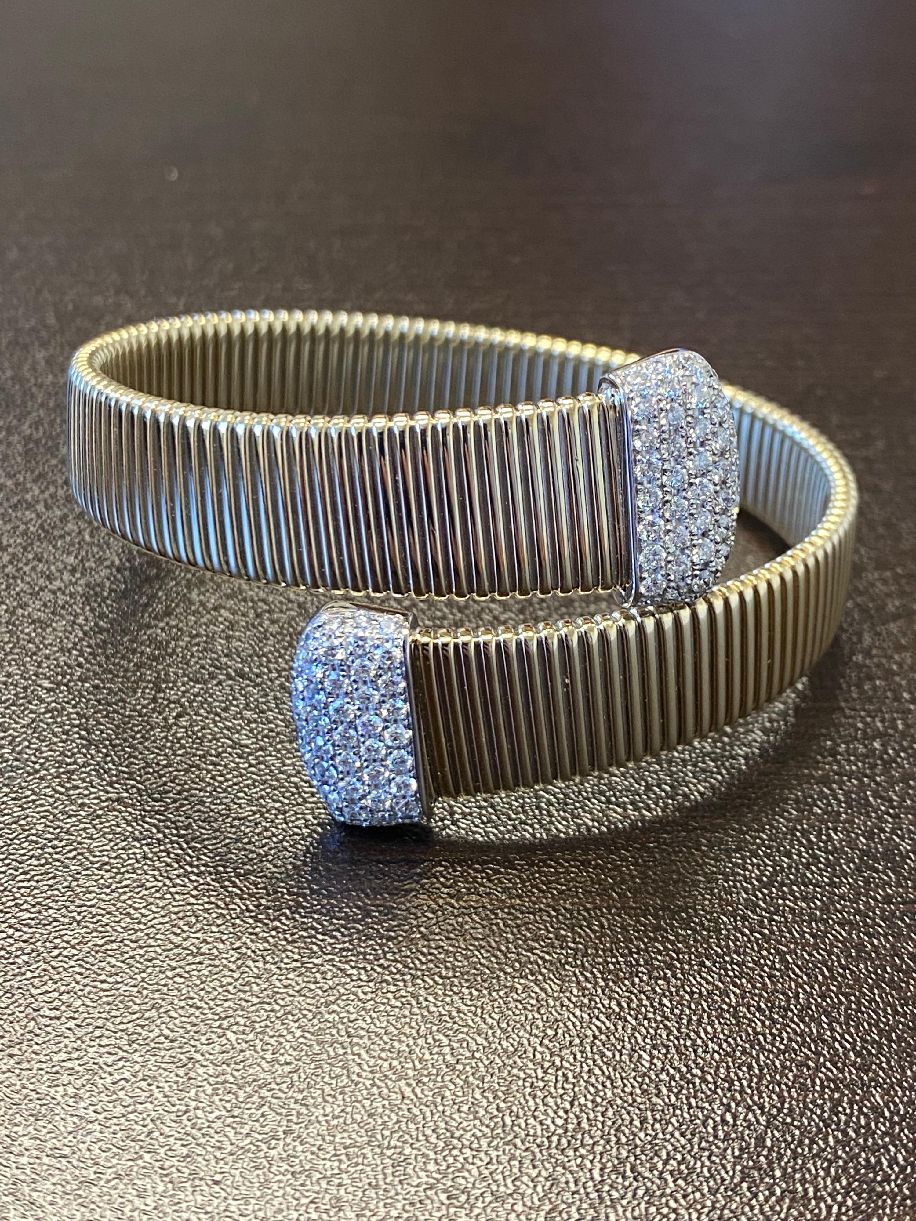 Diamond flex Tubogas bangle set in 14K yellow gold. The total carat weight of the bangle is 2.14. The color of the stones are G-H, the clarity is SI. The bangle is available in rose gold.