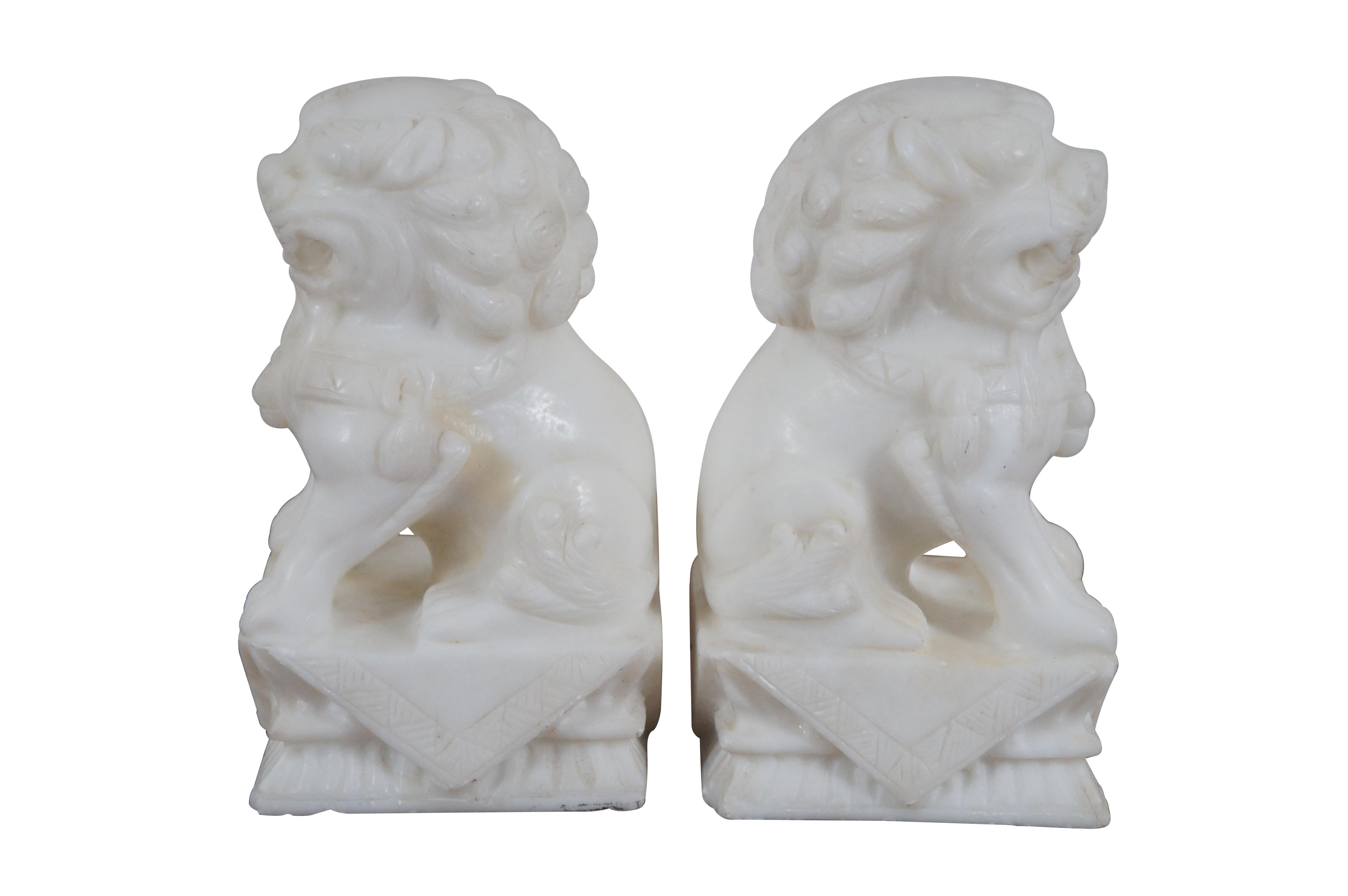 Pair of white marble carved stone fu dogs / Chinese guardian lion figurines or bookends.

Dimensions:
4