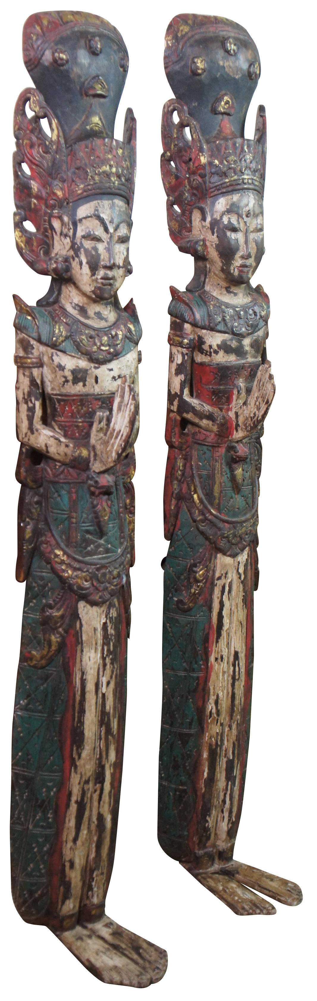 Two vintage 20th century carved wall hanging Thai religious deity / angel figures. Hand carved and painted featuring traditional thepphanom / thephanom pose, which is a Thai term referring to a devata performing the Añjali Mudra praying hand