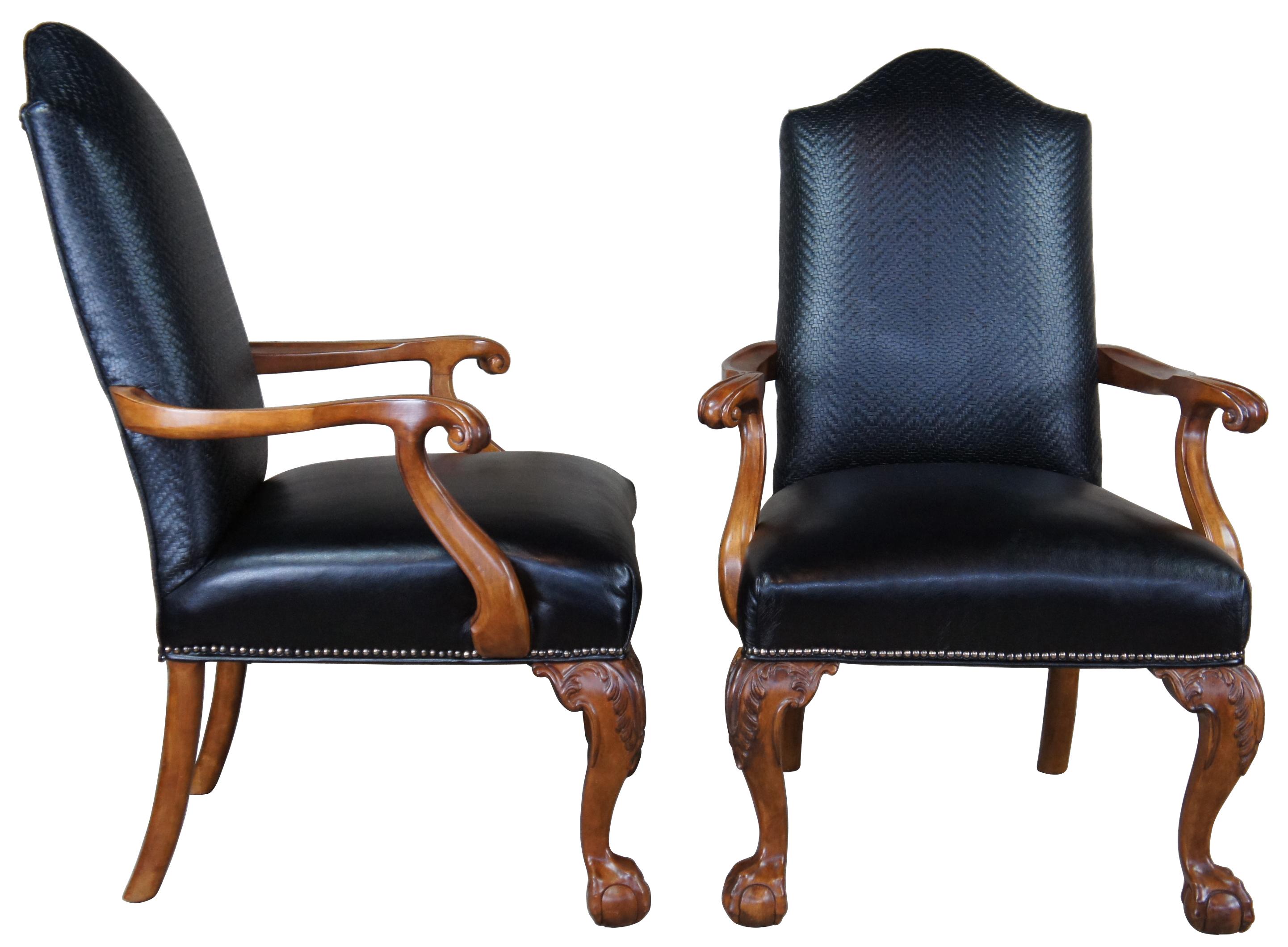 Set of two vintage Century Furniture arm chairs. Featuring ball and claw feet and upholstered in black leather with woven herringbone pattern and nailhead trim.
 