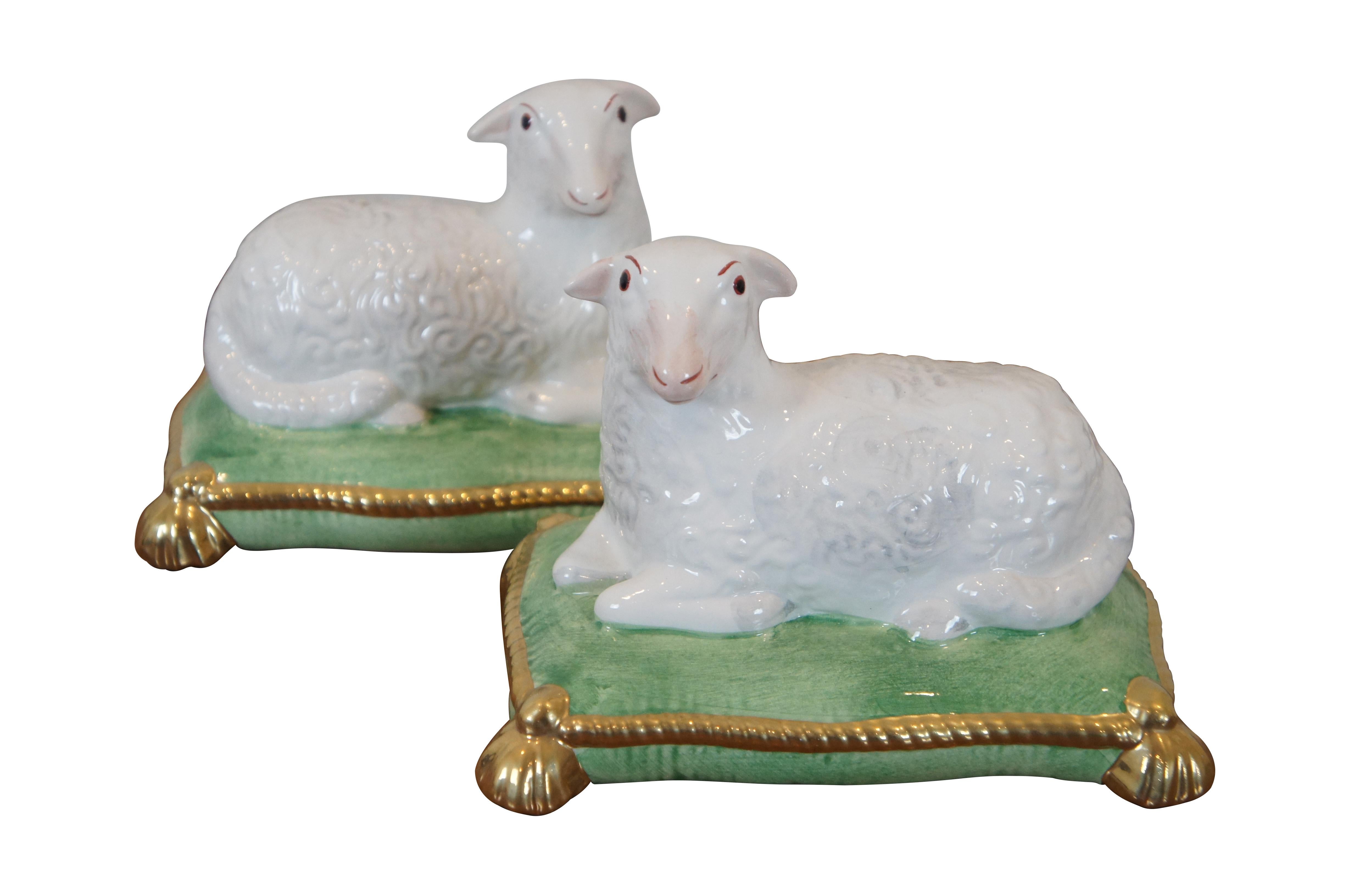 Pair of vintage Chelsea House hand painted porcelain figurines in the shape of sheep or lambs reclining on green cushions trimmed in gold. In the style of 19th century Staffordshire figurines. Made in Italy.

Dimensions:
6.25” x 4.5” x 4.75” (Width