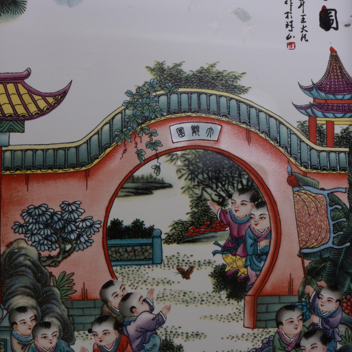 A pair of Chinese pictorial porcelain tiles feature hand painted village scenes with figures, chop mark signed upper, seated in wood frames, 20th century

Measures: frame 13