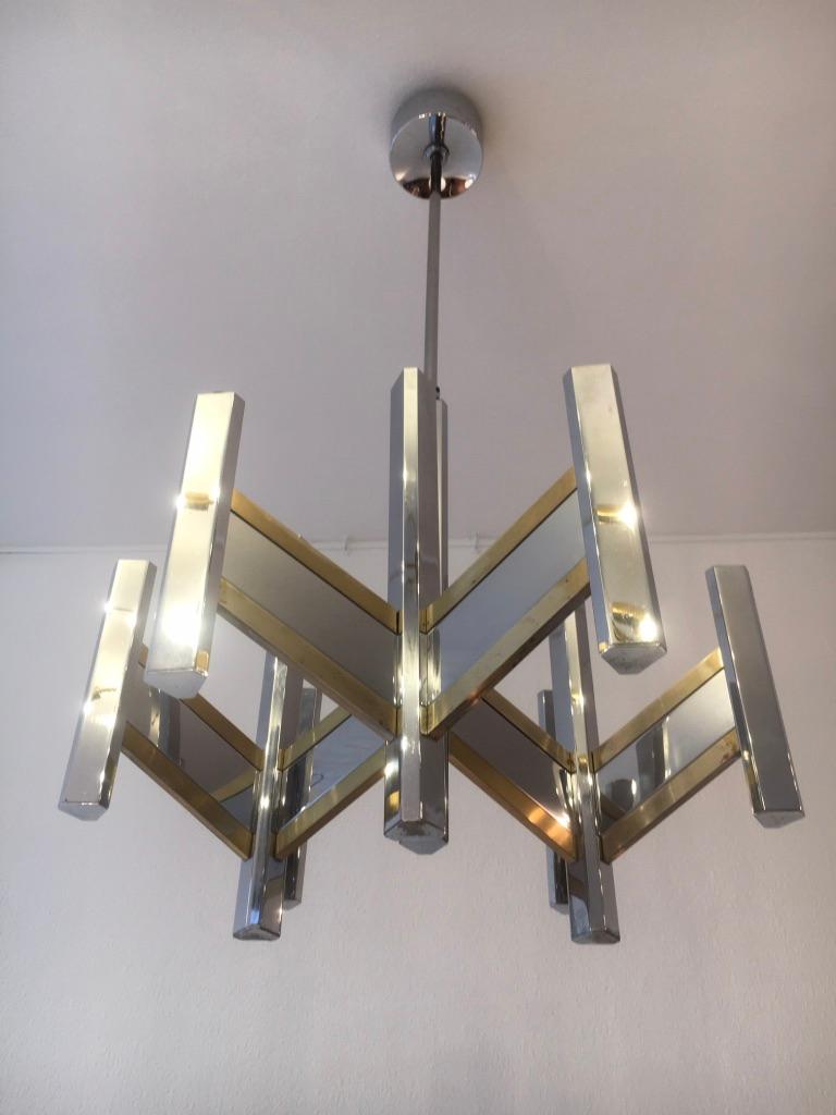 2 identical chrome and brass 9 bulbs chandelier by Gaetano Sciolari, Italy, circa 1970s.
Very good condition. Manufacturer label.
Measures: H 95 x D 55 cm.