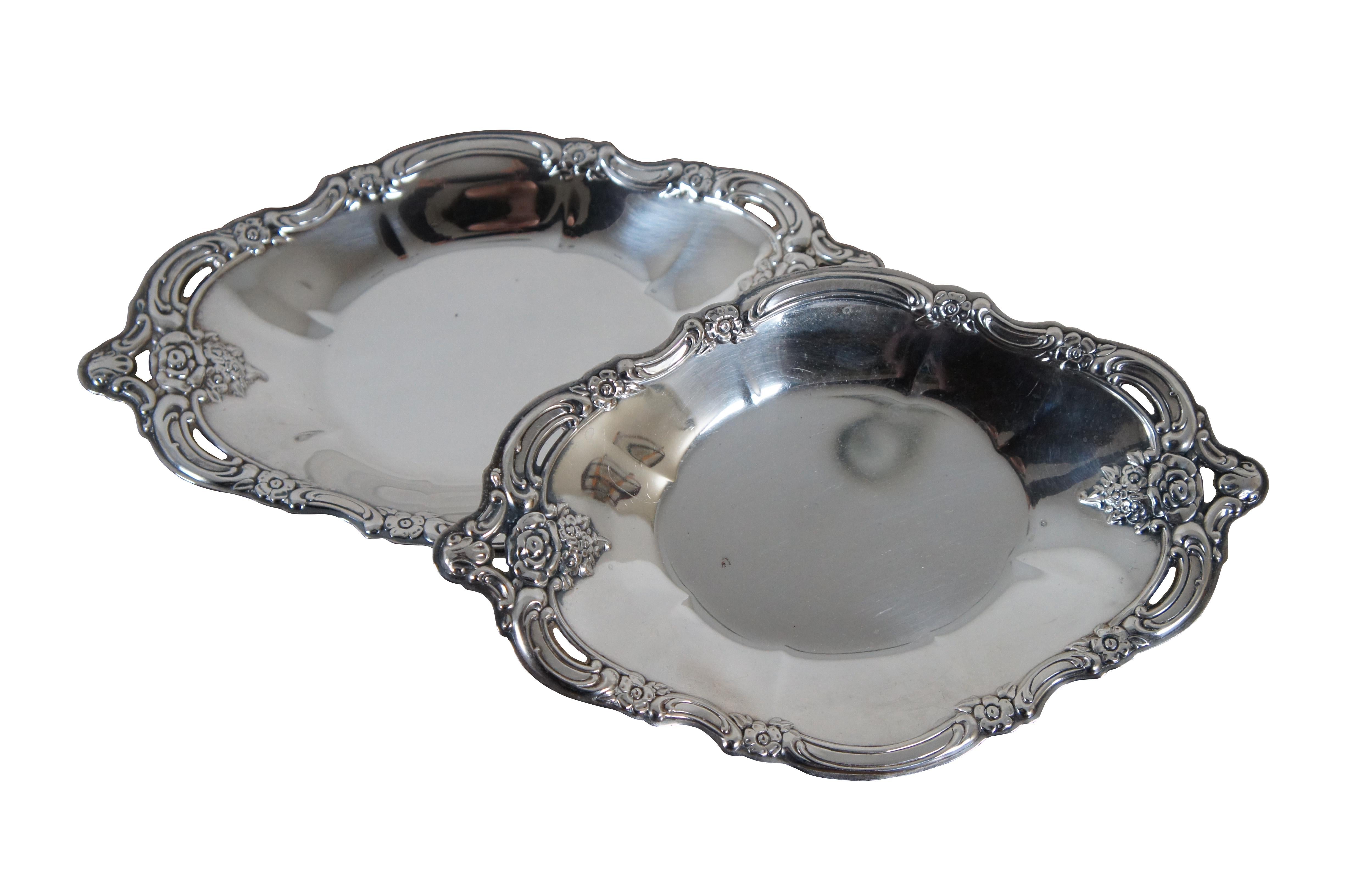 Pair of Community silverplate bon bon bowls / oval dishes in the Silver baroque  Artistry pattern, featuring scrolls and flowers lining the scalloped edge with pierced accents.

